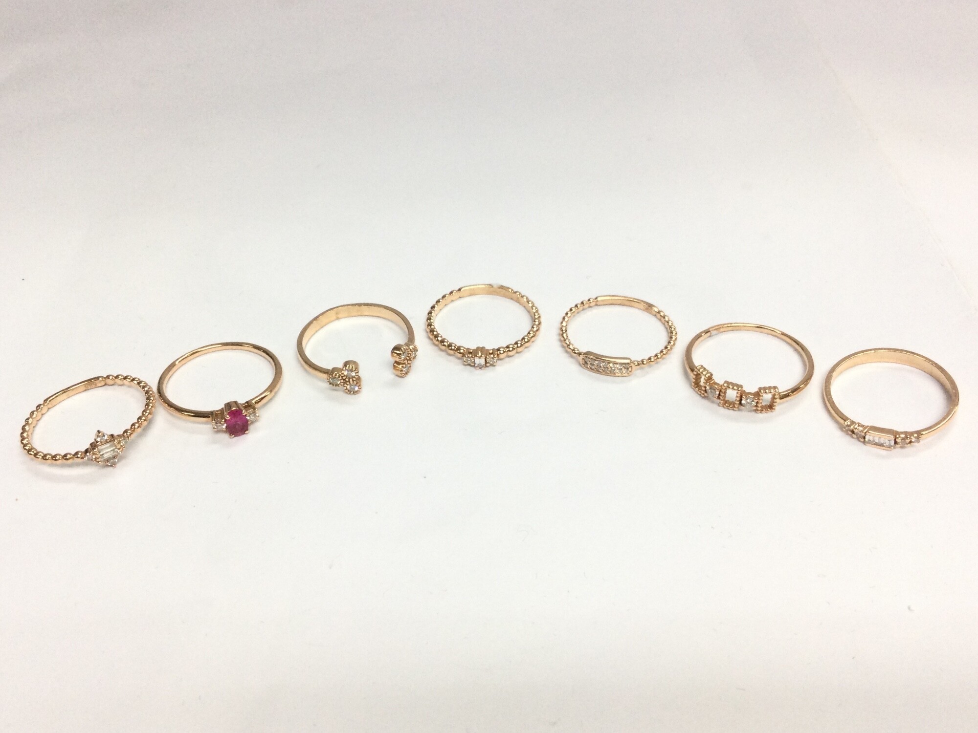 Seven 14ct rose gold diamond set rings, 10.3G total weight. Size N,O