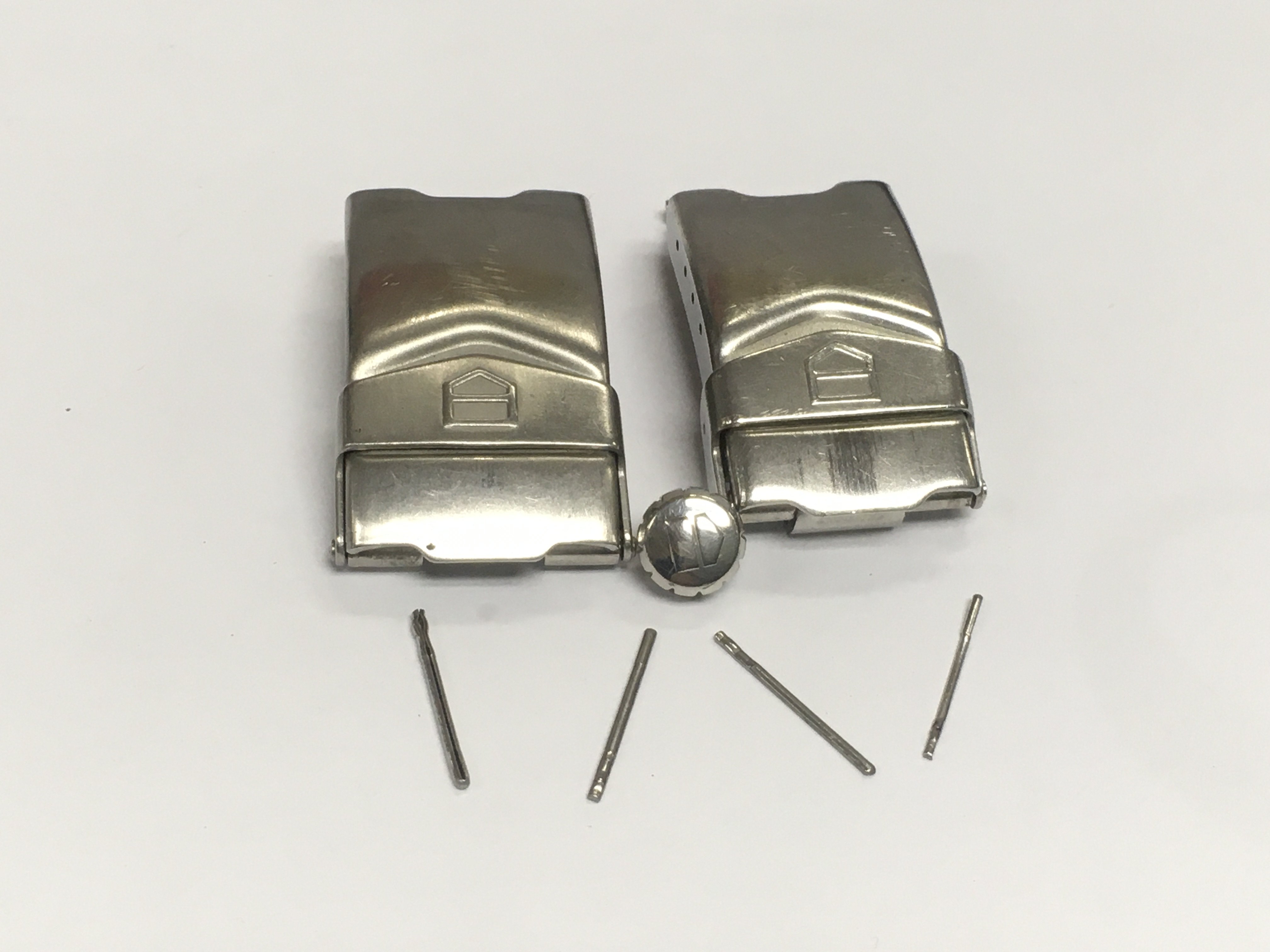 Two gents Tag Heuer watch clasps and button.