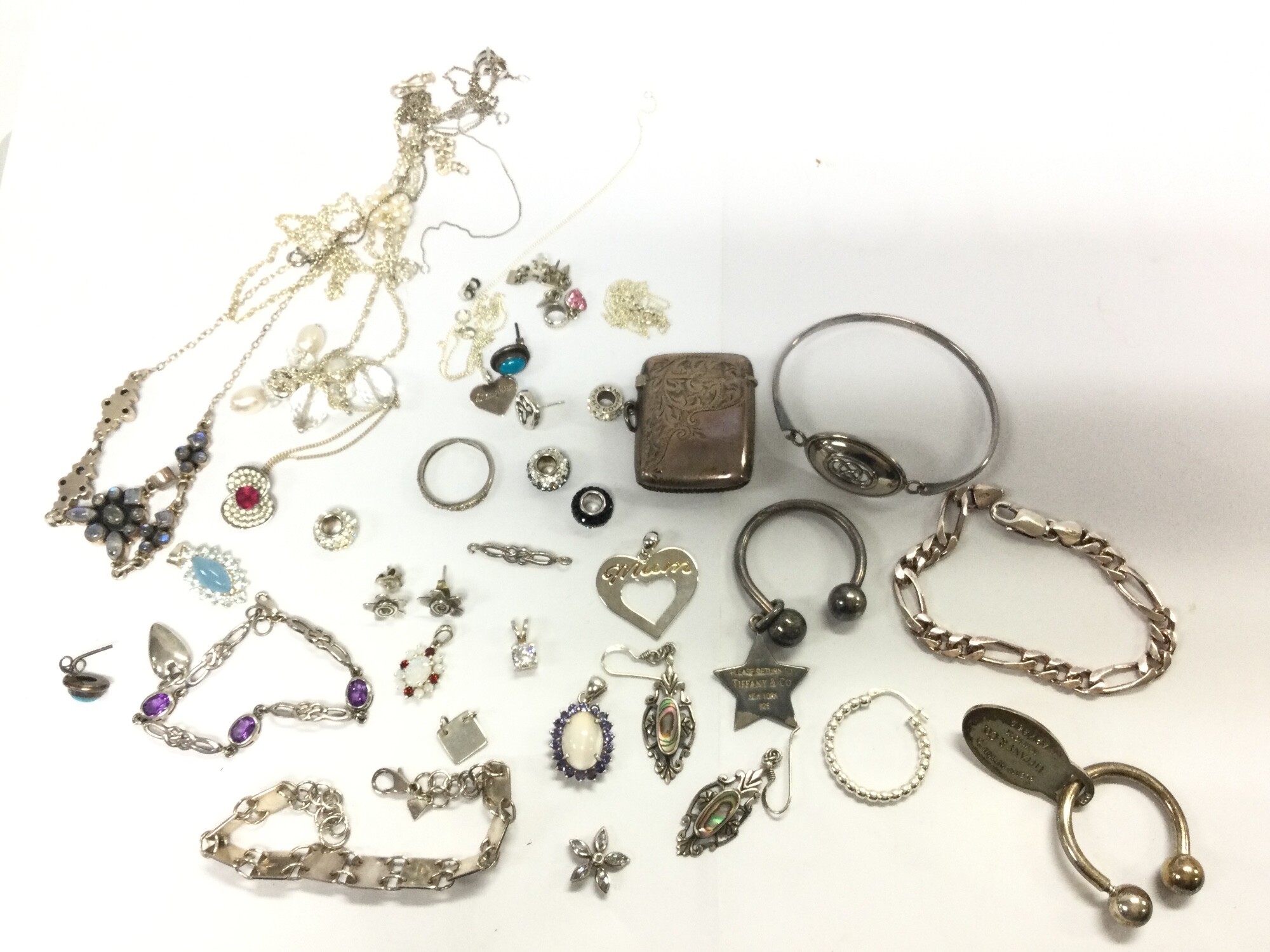 A collection of silver jewellery including earrings, necklaces, bracelets, ruby and opal pendant