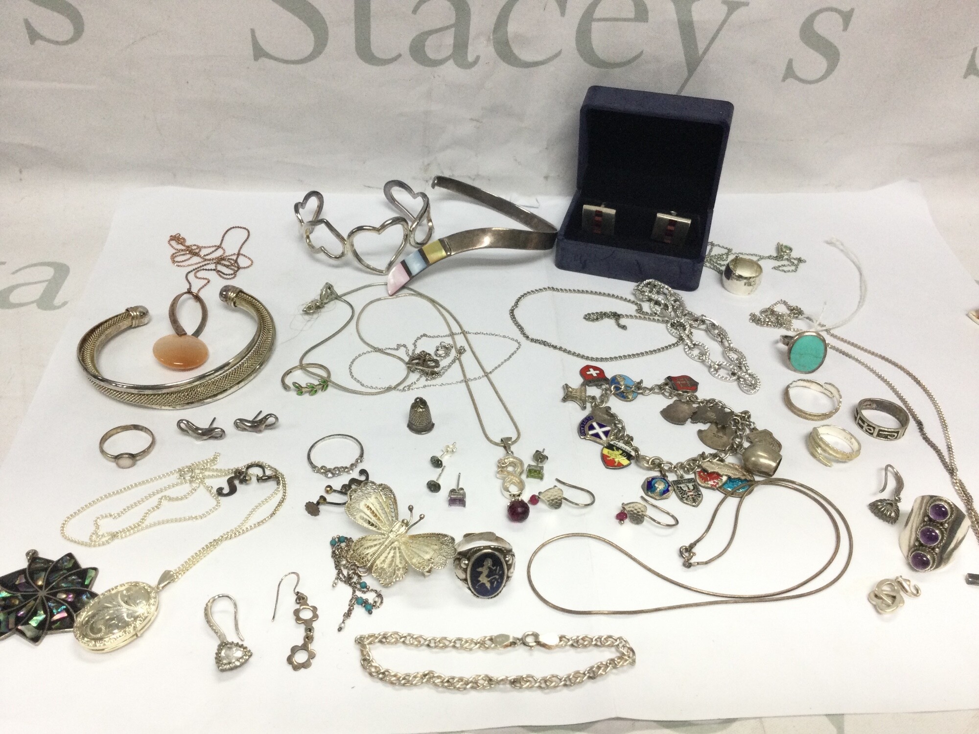 A collection of silver jewellery including brooches, rings, necklaces, cufflinks