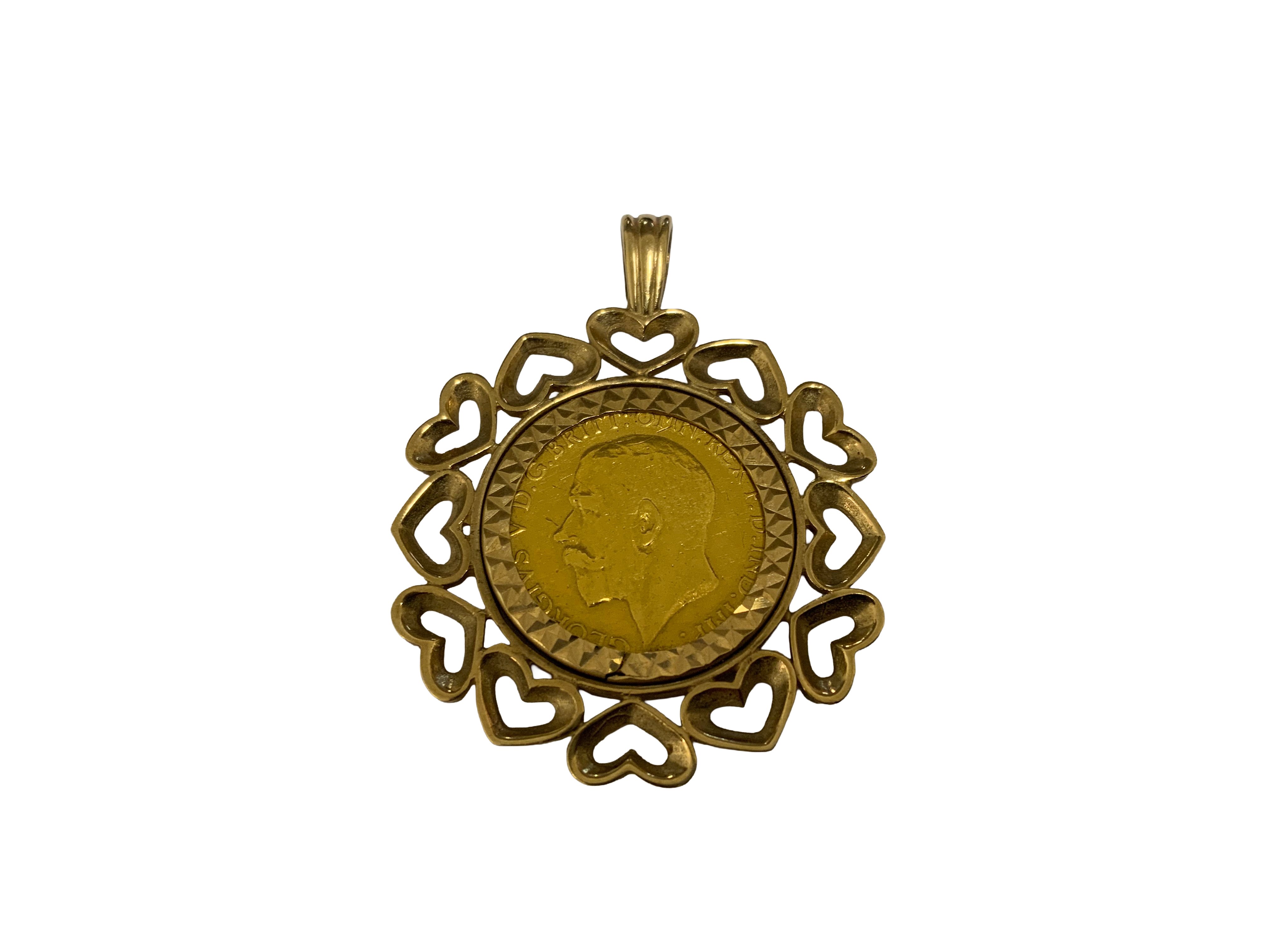 A full George V sovereign, 1918 with a 9ct gold heart design coin mount. 