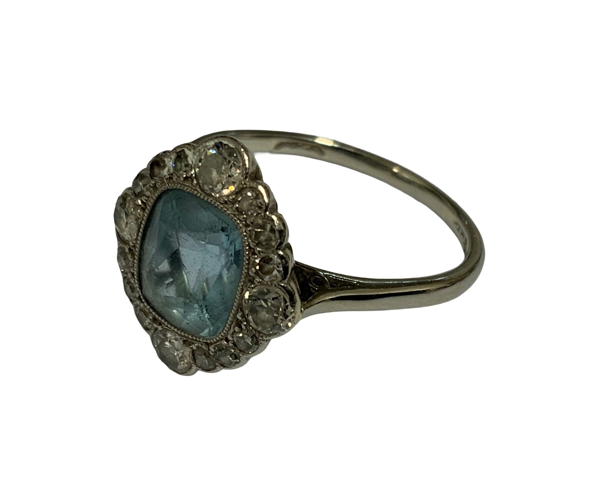 A 1930s platinum ring set with a central aquamarine surrounded by old cut diamonds. Size O.