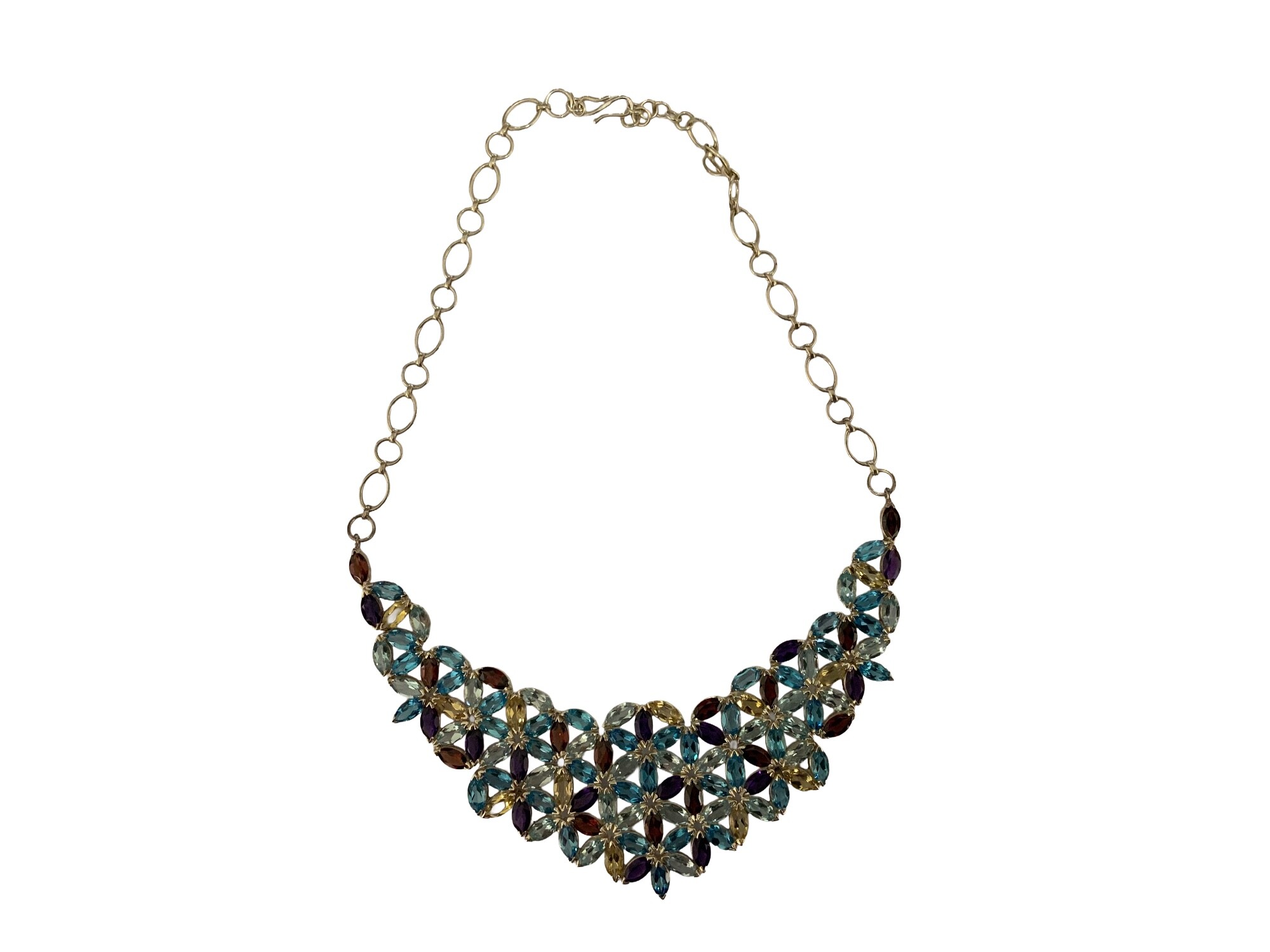 A modern sterling silver collar necklace set with a mixture of Amethyst, Topaz, Citrine and Garnet.
