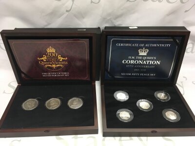 A boxes silver 50p coronation set and Queen Victoria silver portrait set.