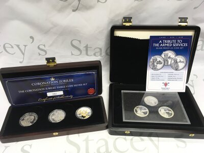 Two sets of silver commemorative coins