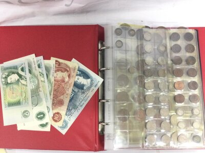 An album of British coinage and banknotes
