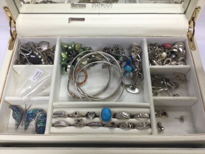 A Jewellery box containing silver Jewellery such as rings, bracelets, necklaces, earrings, ankle chain , brooches, silver charms