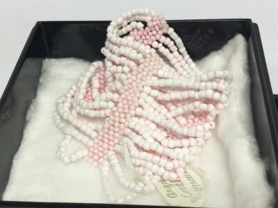 A bracelet cuff elastic and angel coral in a mother of pearl box