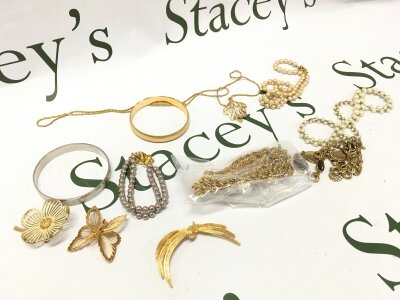 A collection of gold tone jewellery including necklaces, bracelets , brooches etc