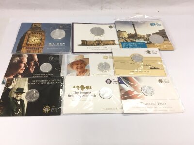 A collection of £100 coins and £20 silver coins.