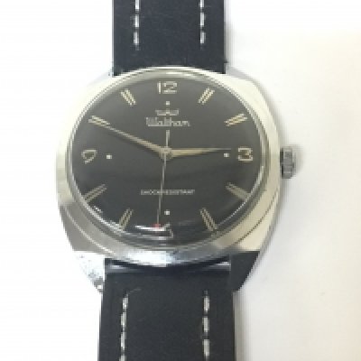 A vintage manual wind Gents Waltham watch with a black dial chrome plated case in very good condition seen working. NO RESERVE