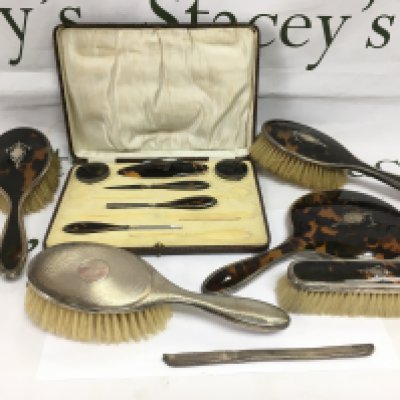 A silver and tortoiseshell dressing table set