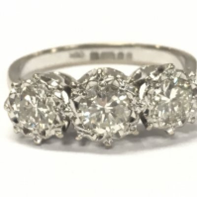 An 18ct white gold three stone diamond ring , size N. Central stone approximately 0.5ct. 3.8g total weight.