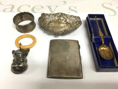 A small collection of silver comprising a dish, napkin ring, cigarette case etc.