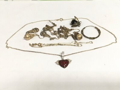 A sacred heart sterling silver pendant and other silver jewellery items.