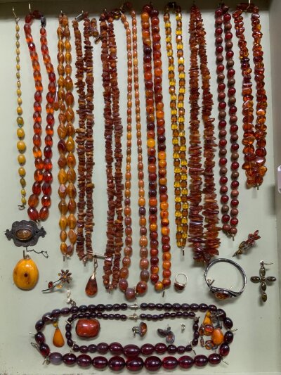 A cased collection of Amber and Simulated amber jewellery to include Sterling silver and gold mounted jewellery items