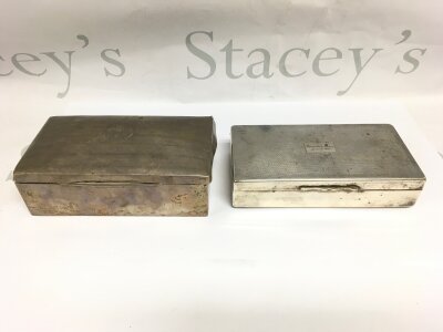 A silver cigarette box, assay indistinct, and a silver plated example (2).