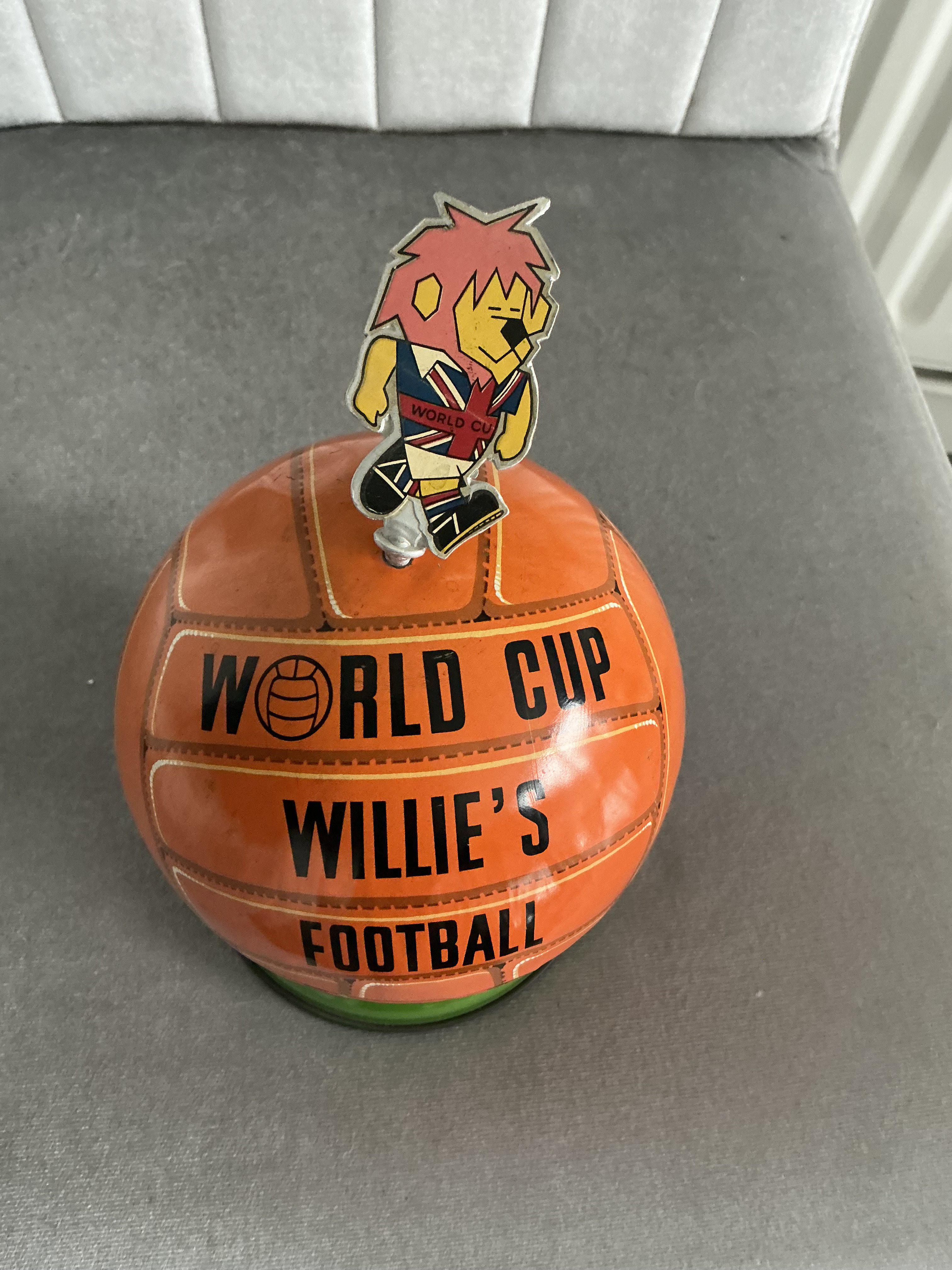 1966 World Cup Willie Lovells Toffee Tin: Stunning toffee tin in very good condition. Seen a few of these and WC Willie is always loose as kids used to open lid with him instead of sliding the join open. When displayed you simply put plaster sine in ball. 