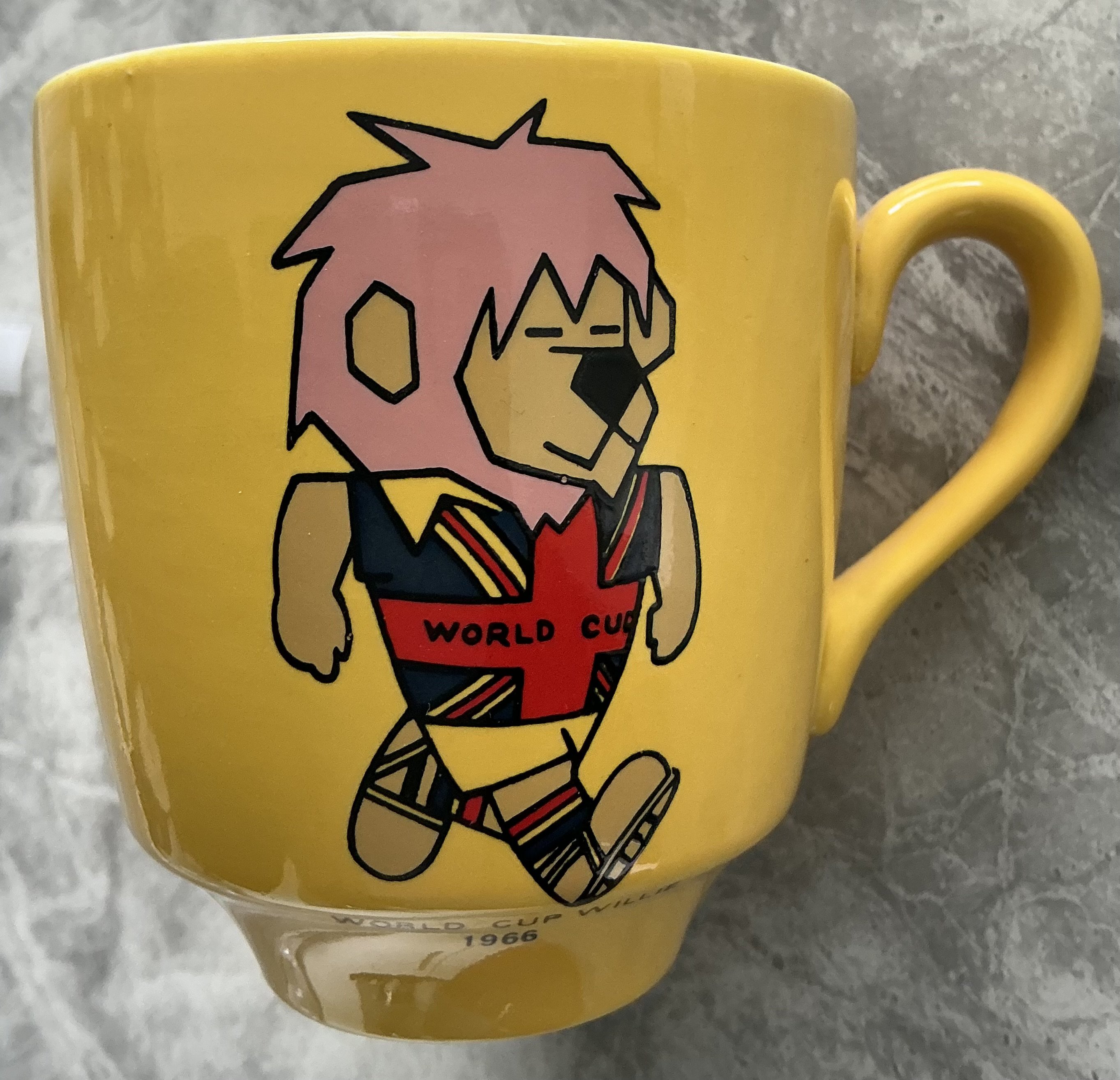 1966 World Cup Willie Yellow Football Mug: Stunning condition mug with a colourful WC Willie to one side. Football Association copyright to base. 