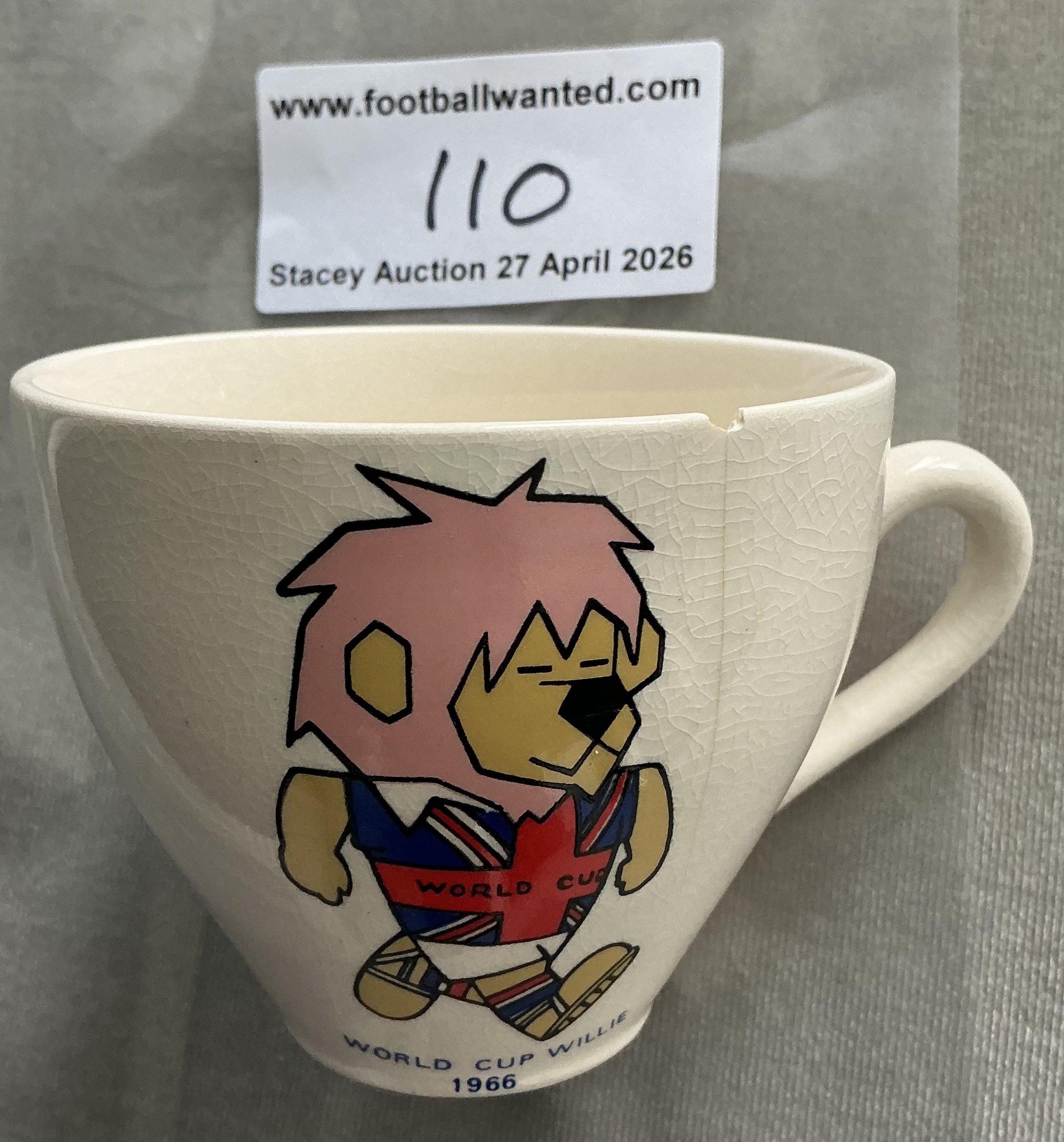 1966 World Cup Willie Football Tea Cup: White tea cup featuring a colourful WC Willie to one side. Different style to lot 101. Tiny chip and crack. 