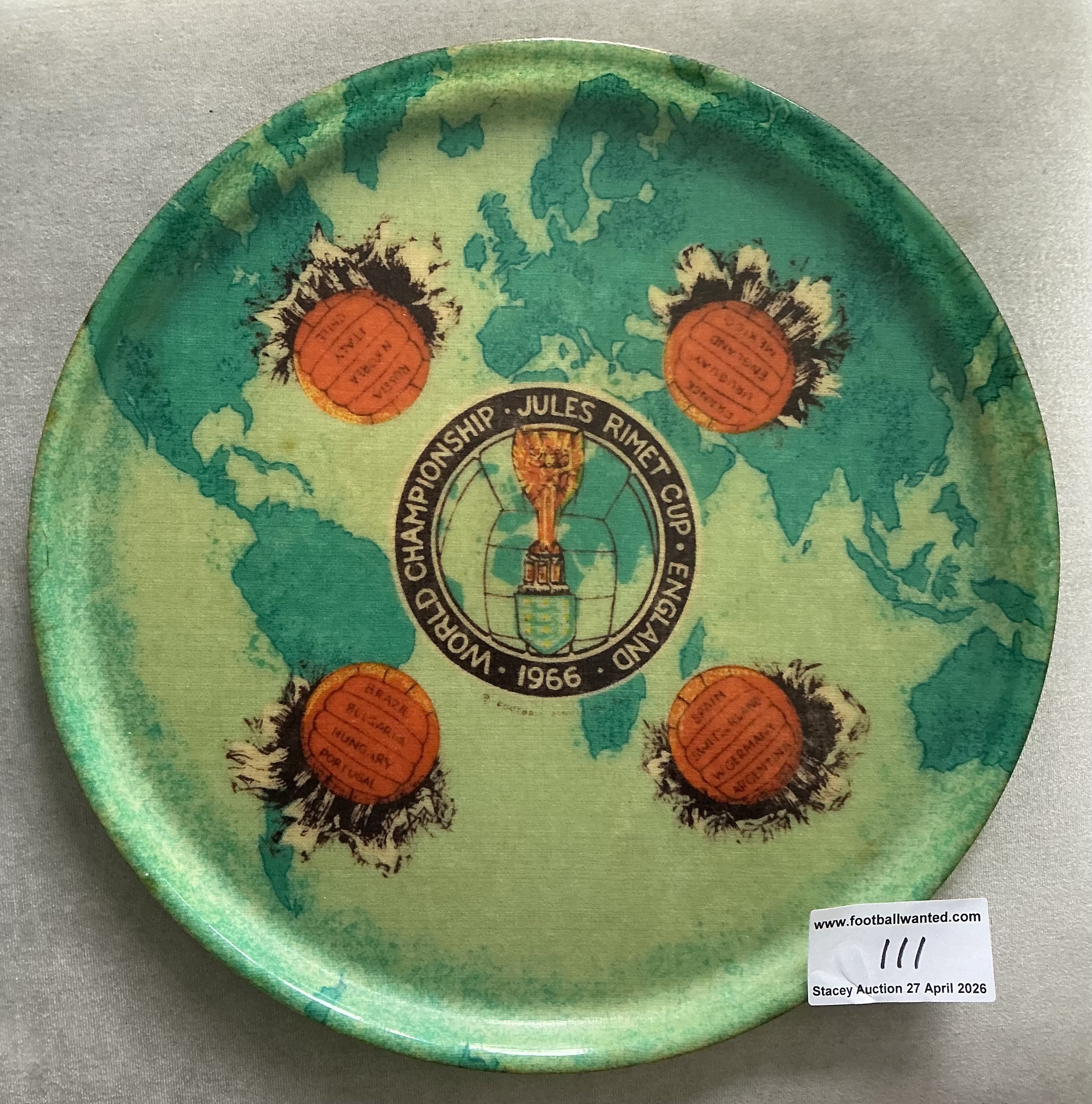 1966 World Cup Football Tournament Tray: Large 14 inch plastic green tray featuring in the middle the Jules Rimet trophy and the words Jules Rimet Cup 1866 World Championship. The rest of the tray has four footballs all with 4 participating teams. Nice item. 