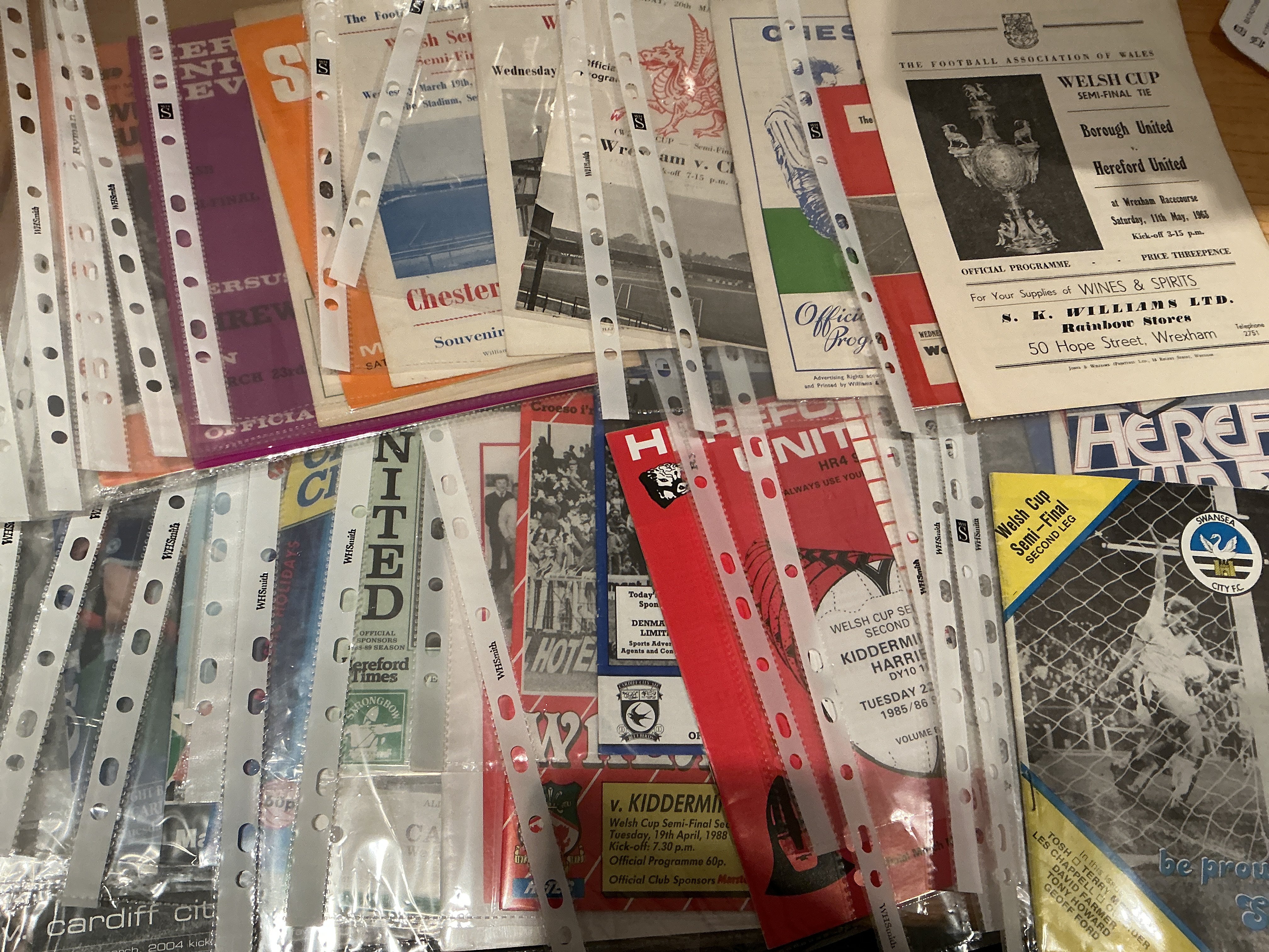 Welsh Cup Semi Final + Final Football Programmes: From 1963 onwards with matches played at Wrexham Chester Swansea Hereford and Newport. There are 30 semi finals and 23 finals. Excellent with instructions to sell. (53)