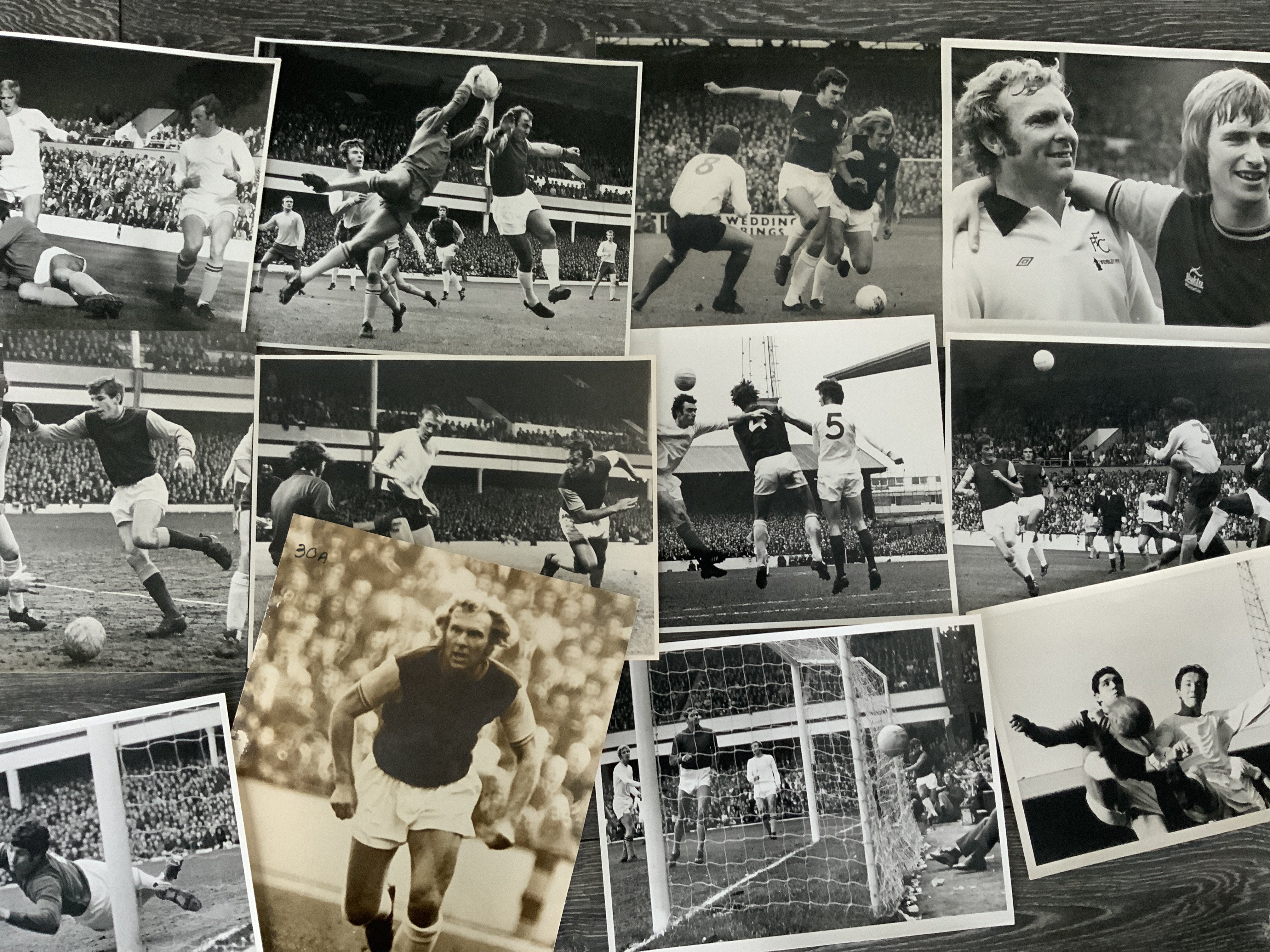 1960s + 1970s West Ham Football Press Photos: Whilst all press photos on that old thick paper only half have press stamps to rear. Includes action pictures of Moore Ferguson Hurst Greaves Peters Sealey and Best. C/W a few pictures from the 1975 FA Cup final and a couple more recent. Mainly large. (23)