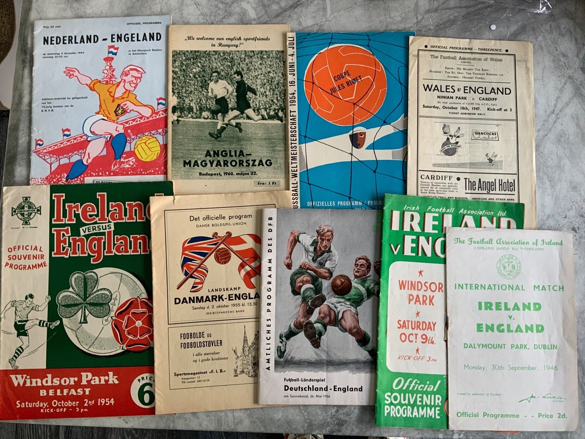 England Away Football Programmes: 1954 World Cup v Belgium, 1947 Wales, 1955 Denmark, 1946 1948 1954 Ireland, 1956 Germany, 1960 Hungary, 1964 Holland. Excellent. (9)