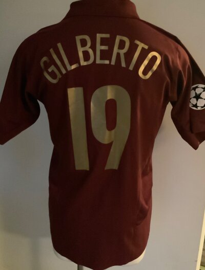2005 - 2006 Arsenal Match Worn Redcurrant Football Shirt: Champions League Shorthouse sleeve shirt from the last season at Highbury. Number 19 Gilberto to rear and a champions League arm badge.