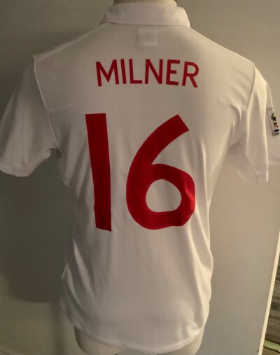 England 2010 World Cup Match Prepared Football Shirt: White shirt with number 16 Milner to rear and number 16 to front. South Africa 2010 World Cup sleeve badge. Genuine source and shirt but not issued for match.