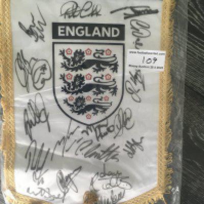 England U21 Signed Football Pennant: Official England pennant signed by 16 players brought back by Peter Barnes the Tottenham + West Ham club secretary who travelled with the touring party. (year unknown).