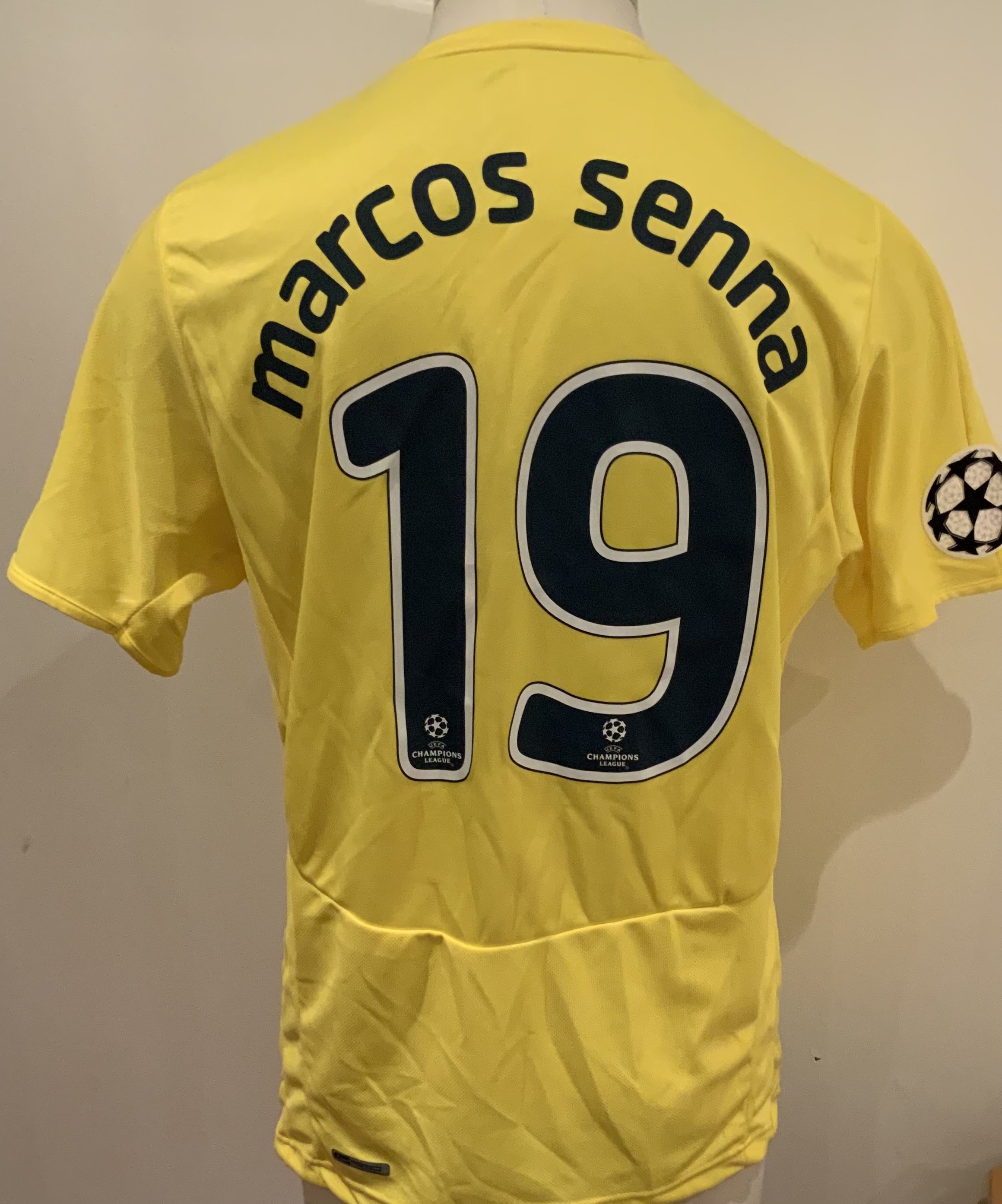 Villarreal Match Worn Football Shirt: Yellow short sleeve number 19 Puma shirt worn by Marcos Senna. Good condition with Champions League badge to right sleeve and Champions League detail to numbers.