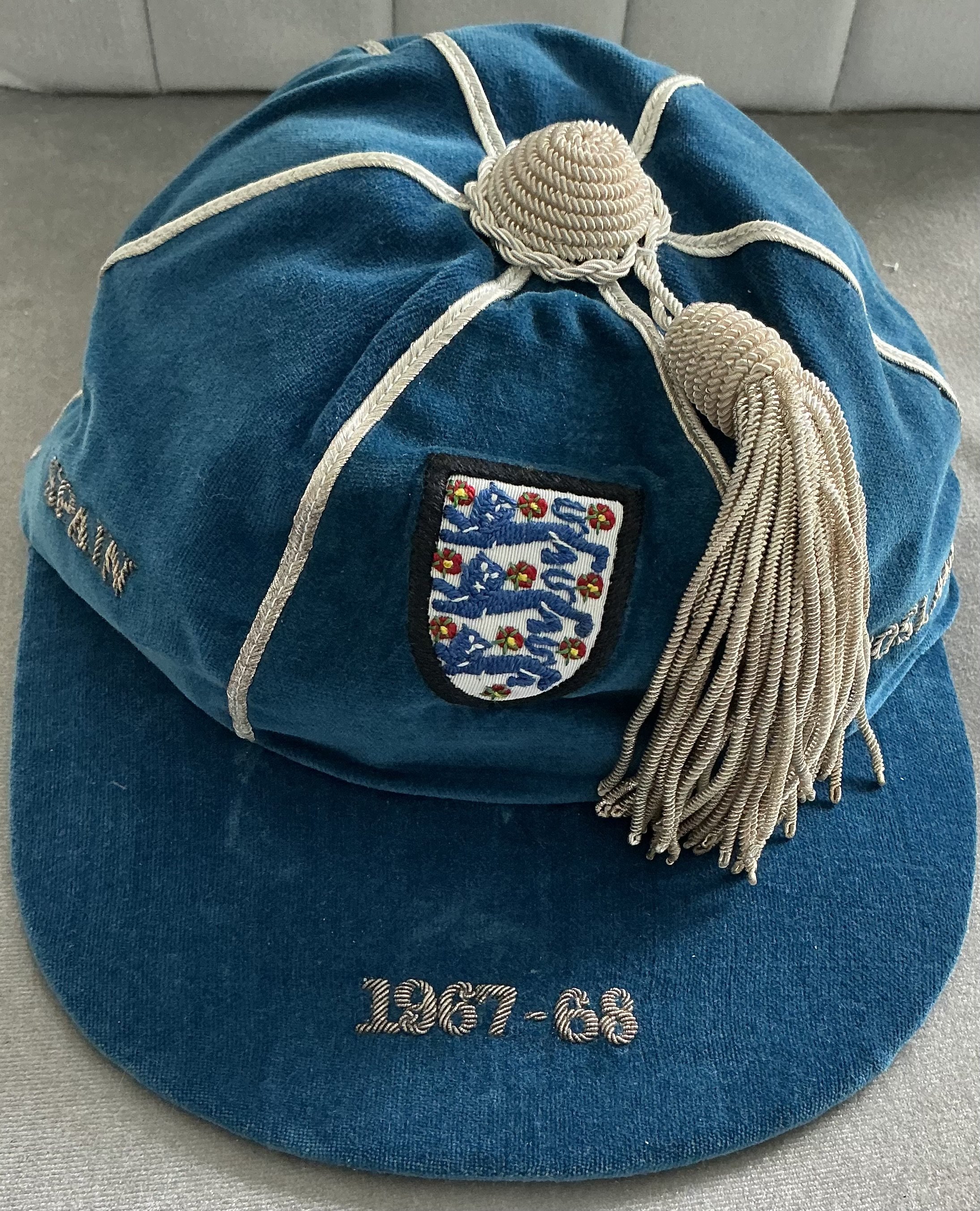 England 1968 Euros Full International Football Cap: Good condition blue cap awarded to World Cup winner Ray Wilson for playing in the 1968 Euro Championships. There were only 4 teams in the finals. This cap covers 2 matches v Soviet Union and Yugoslavia plus Spain who they played twice to qualify. Round the edge of the cap are the words Spain Spain Yugoslavia USSR. This was presented in a thick card box and Wilson has written to front and signed box. He has written the information of matches to front and the words last cap which in fact it was for the 1966 World Cup winner.
