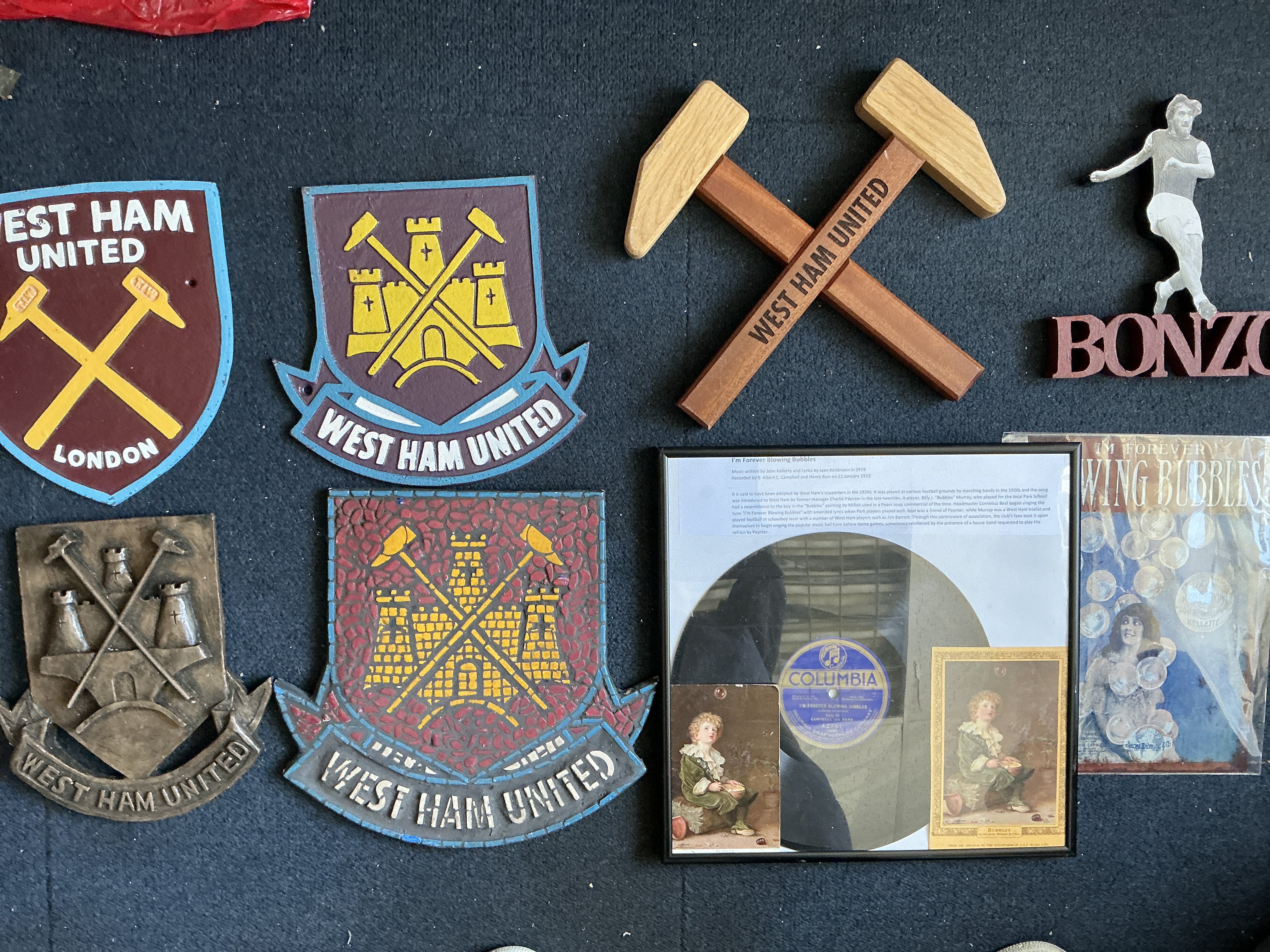 West Ham Man Cave Football Collectables: Some one off items to include two very heavy old and new badge West Ham metal signs, West Ham wooden hammers and other signs. C/W an old Im Forever Blowing Bubbles framed record plus postcard.