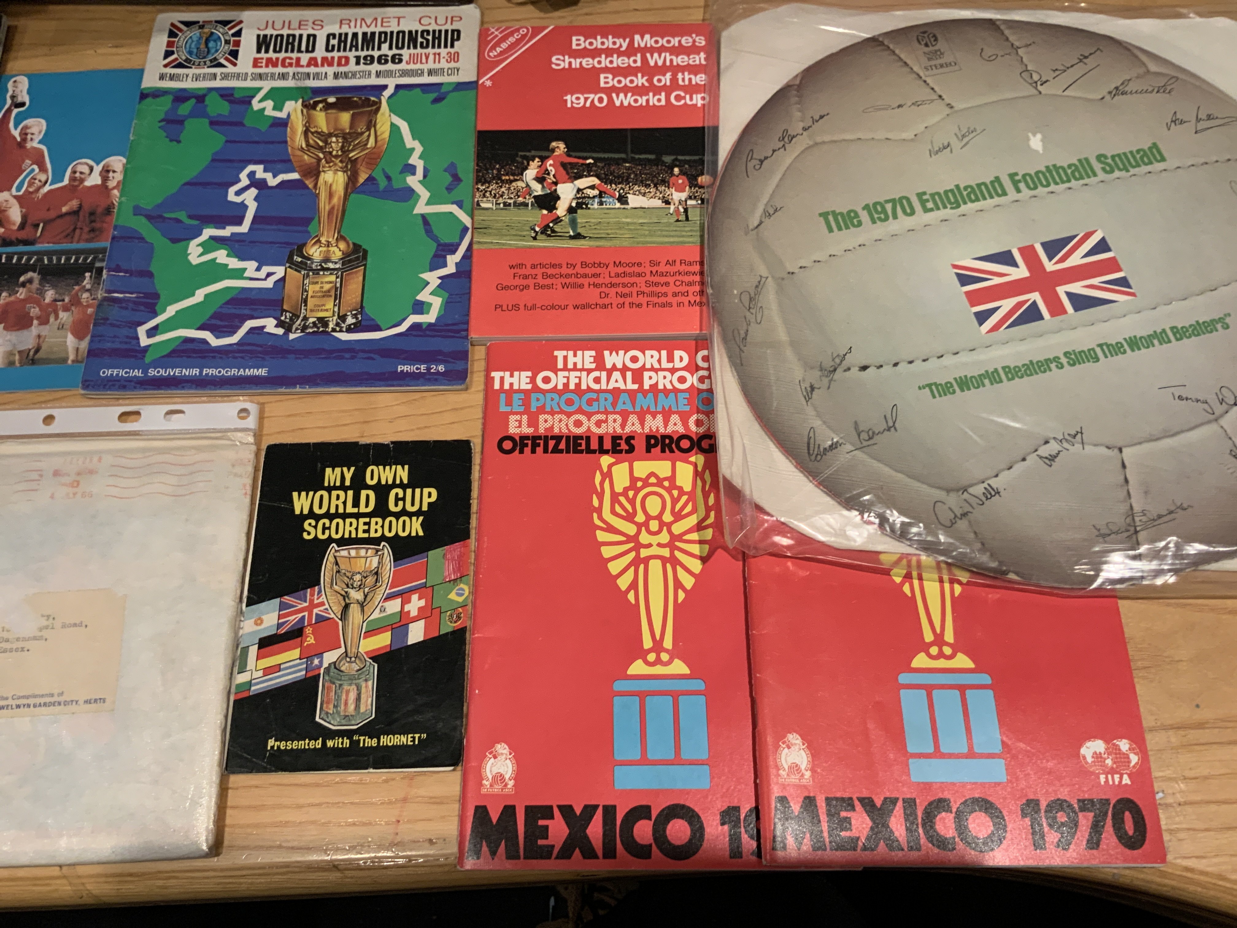 1966 + 1970 World Cup Football Memorabilia: From 1966 Shredded Wheat puzzle in original envelope, tournament brochure, Hornets World Cup scorebook and Wizard World Cup booklet. C/W from 1970 World Cup two programmes, Wolstenholmes wallchart and other guide books from Moore Best and others plus the England squad record.