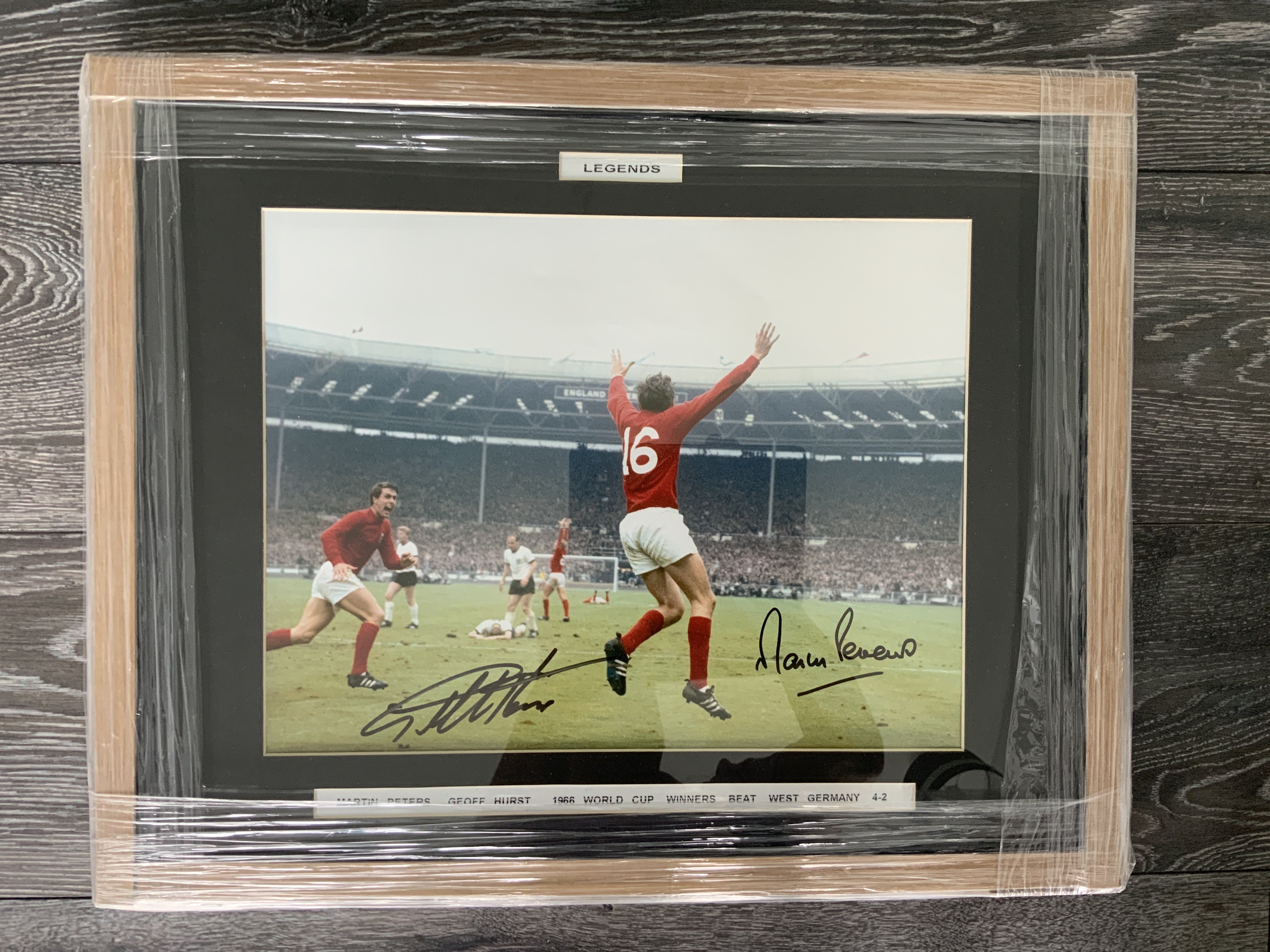 1966 England World Cup Winning Goal Scorers Signed Framed Photo: Large colour photo of Peters celebrating after scoring with Hurst which they have both signed. Measures 21 x 17 inches. Nicely framed and still in wrappers. Starting price is price of framing.