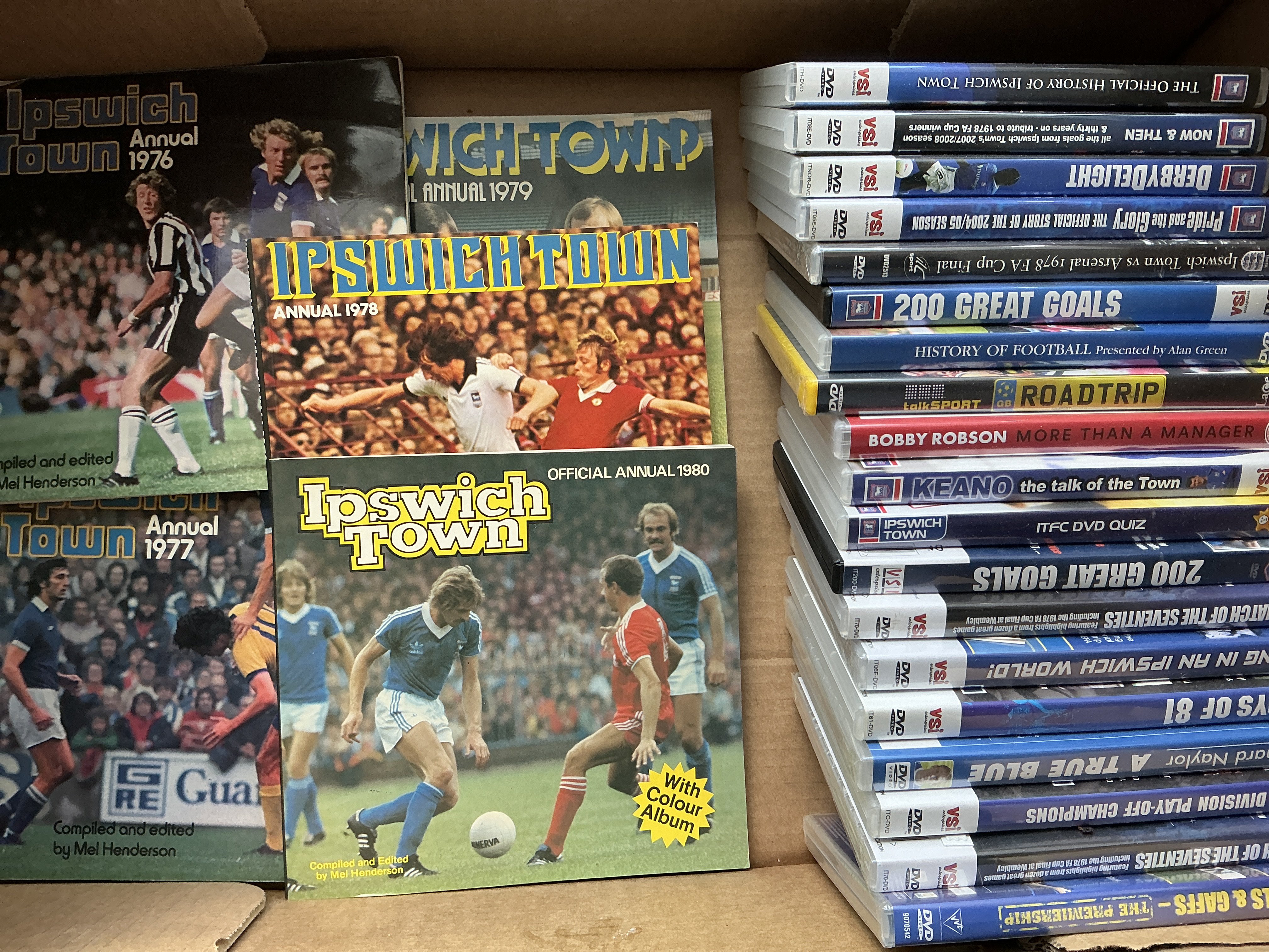 Ipswich Town Football Memorabilia Boxes: Includes 19 DVDs, Annuals, Programme binder with 10 handbooks from 49/50 to 62/63, Programme binders with more recent handbooks and magazines such as Turnstyle Blues and Town Collectables, 7 + 12 inch records, The Men Who Made Town book plus much more. (2 boxes)