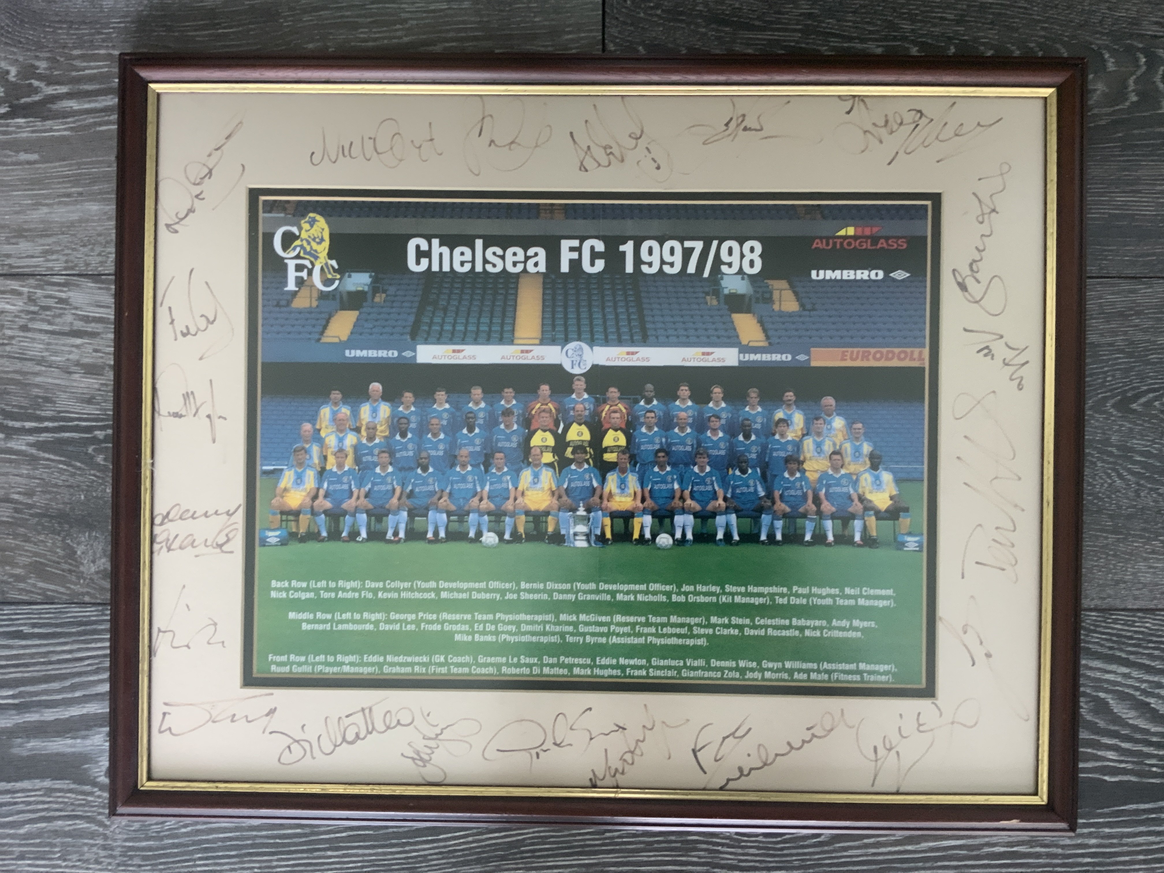 Chelsea 97/98 Framed Signed Football Photo: 21 autographs on a mount with picture of the team and the FA Cup sitting proudly at the front. Autographs include Le Saux Di Matteo and first team coach Graham Rix. Frame measures 22 x 17 inches.