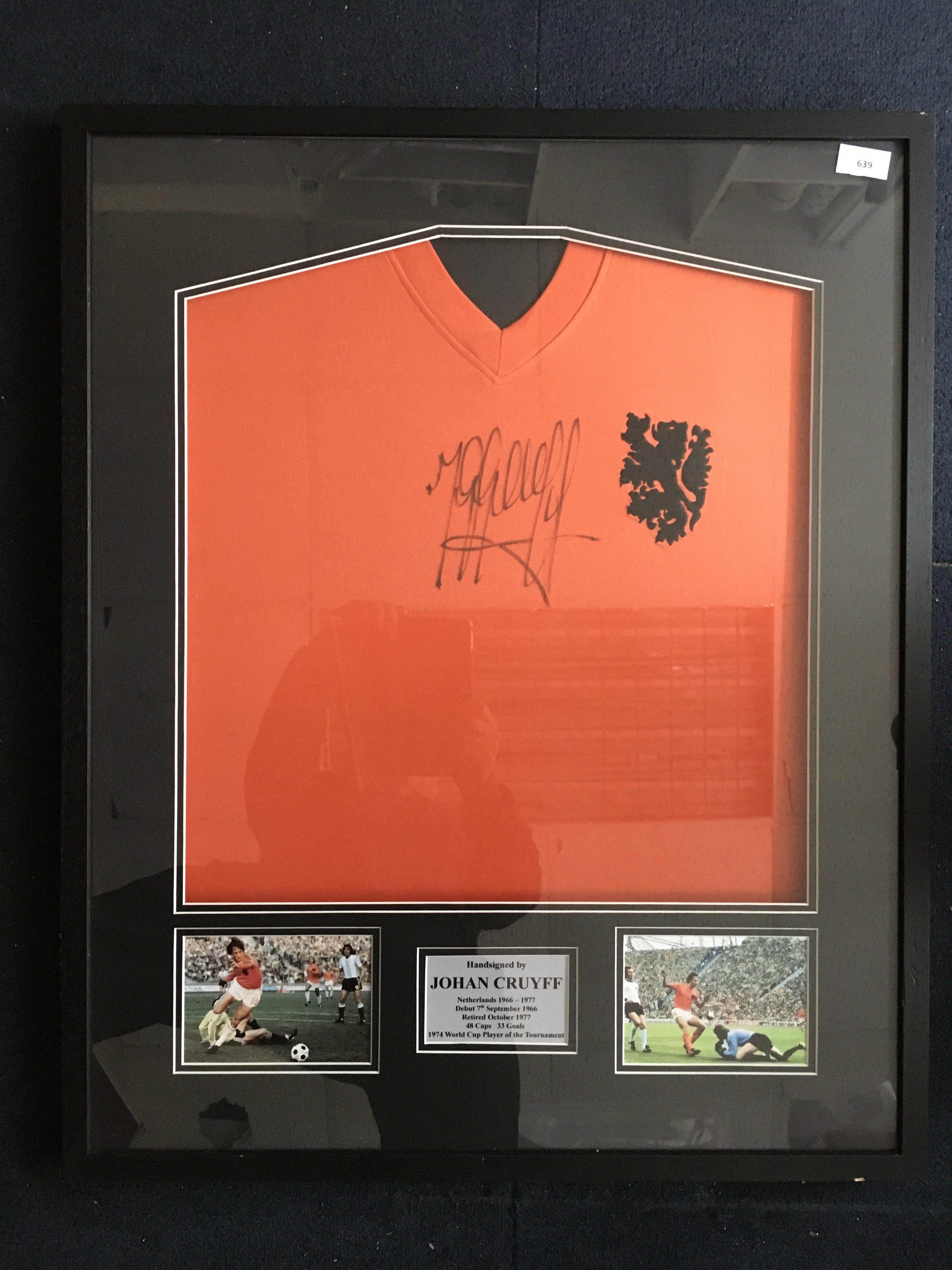 Johan Cruyff Signed Framed Holland Football Shirt: Netherlands replica 1974 World Cup shirt hand signed boldly by the 1974 World Cup player of the tournament. Nicely framed with two pictures of him in similar kit.