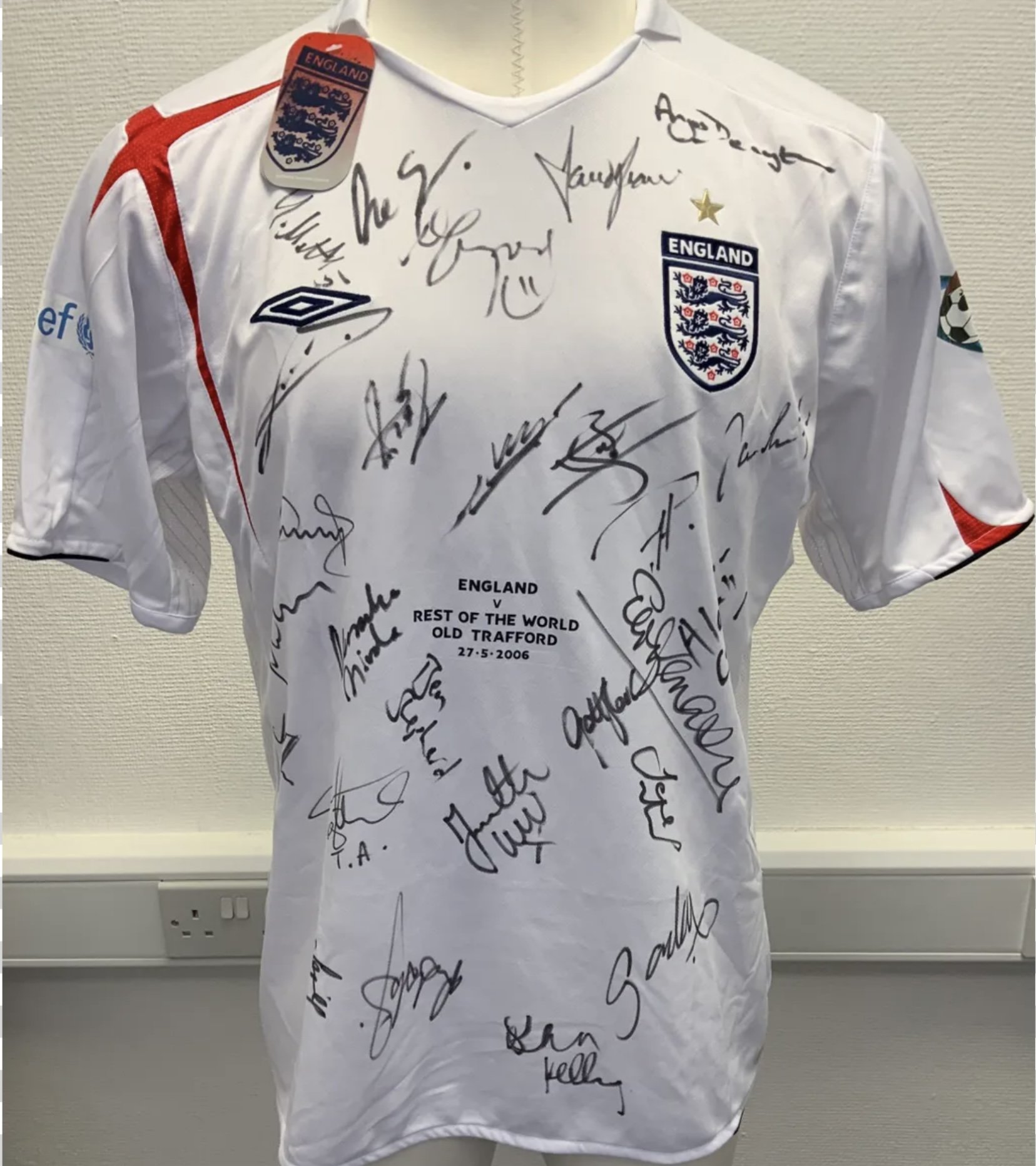 England + Rest Of The World 1st Ever Soccer Aid Signed Football Shirts: Incredibly rare match prepared shirts for both teams in the first ever Soccer Aid in 2006. Unused with labels attached sent back to Umbro as a thank you for supplying both kits for free. Shirts never available for sale so no price label on tags. 26 genuine autographs on England shirt with 23 on Rest Of The World shirt. Autographs include Robbie Williams Angus Deayton Ben Shepherd David Seaman Terry Venables Gazza Les Ferdinand and Gordon Ramsey. (2)