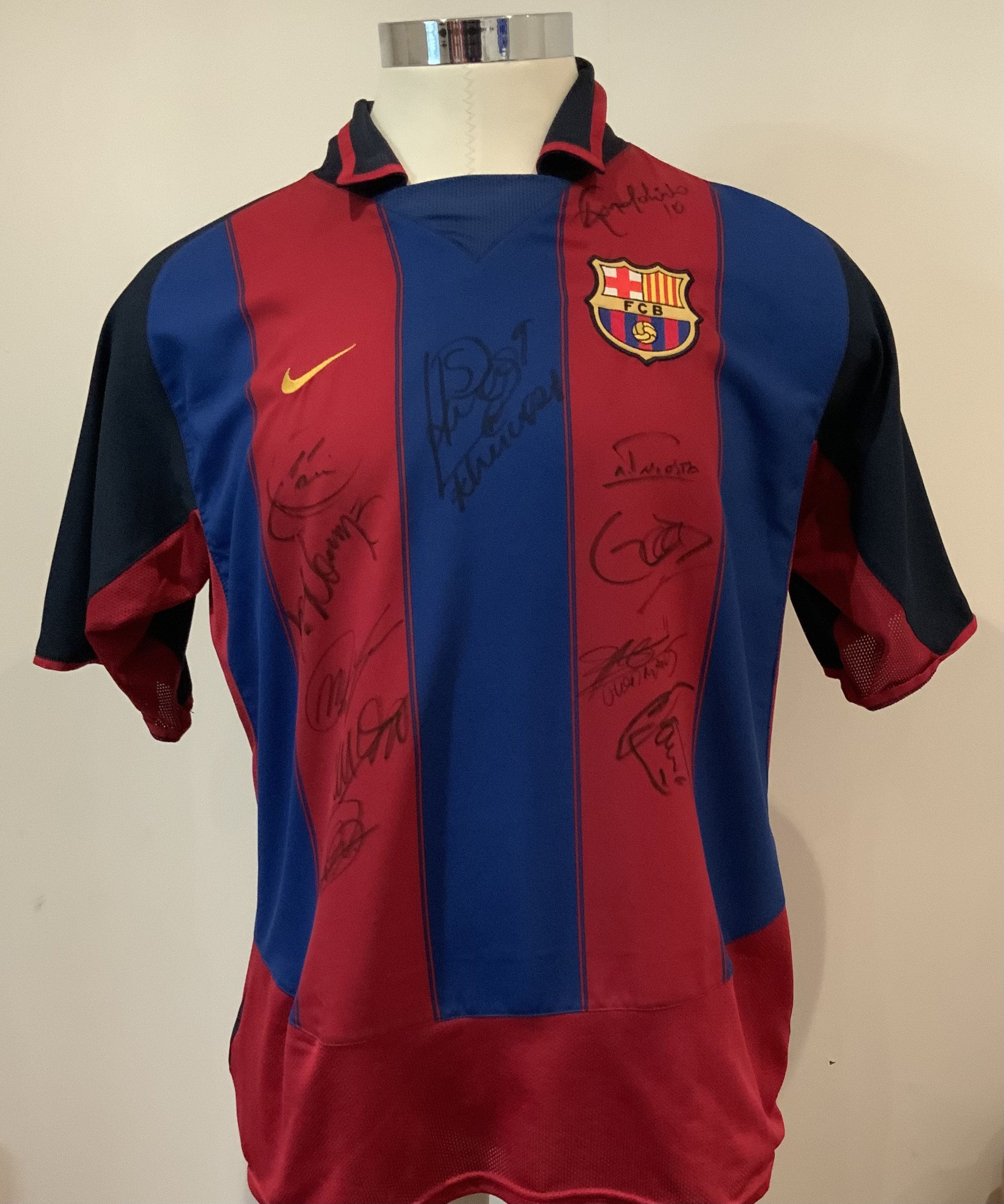 Barcelona Multi Signed Match Worn Football Shirt: Nike number 14 shirt signed by 12 worn by Gerard Lopez, in the Opening Match at the City of Manchester Stadium, 10th August 2003, between Manchester City and FC Barcelona. The shirt has been signed by twelve members of the Barcelona team, most notably Ronaldinho. The shirt was obtained by Clive Wilkes, Former Premier League Referee, who was Fourth Official in this fixture. Gerard Lopez made six appearances for the Spanish national team.