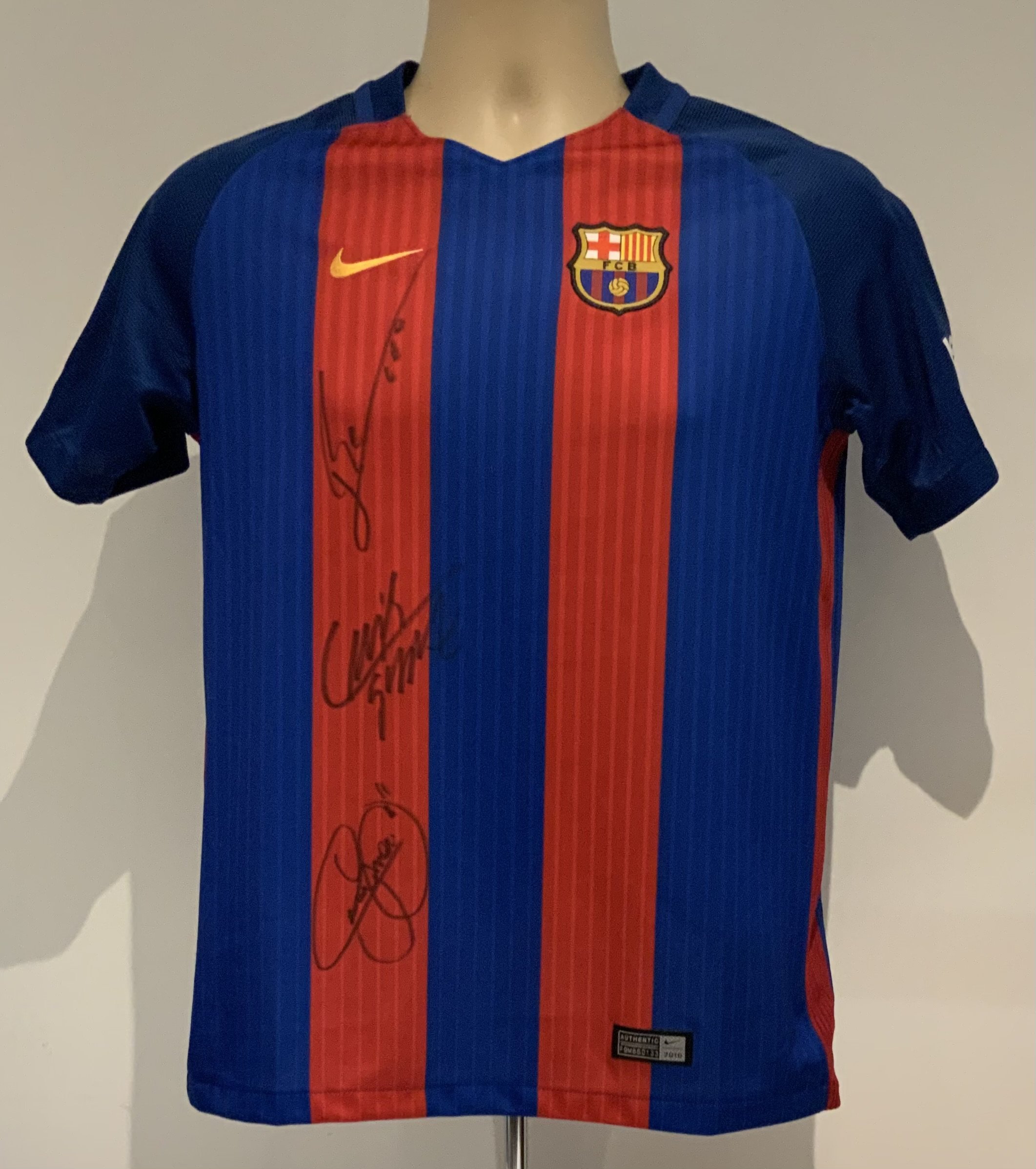 Barcelona Signed Football Shirt: Nike short sleeve shirt signed to the front by Lionel Messi, Luis Suarez and Neymar Jr. Size child's XL.