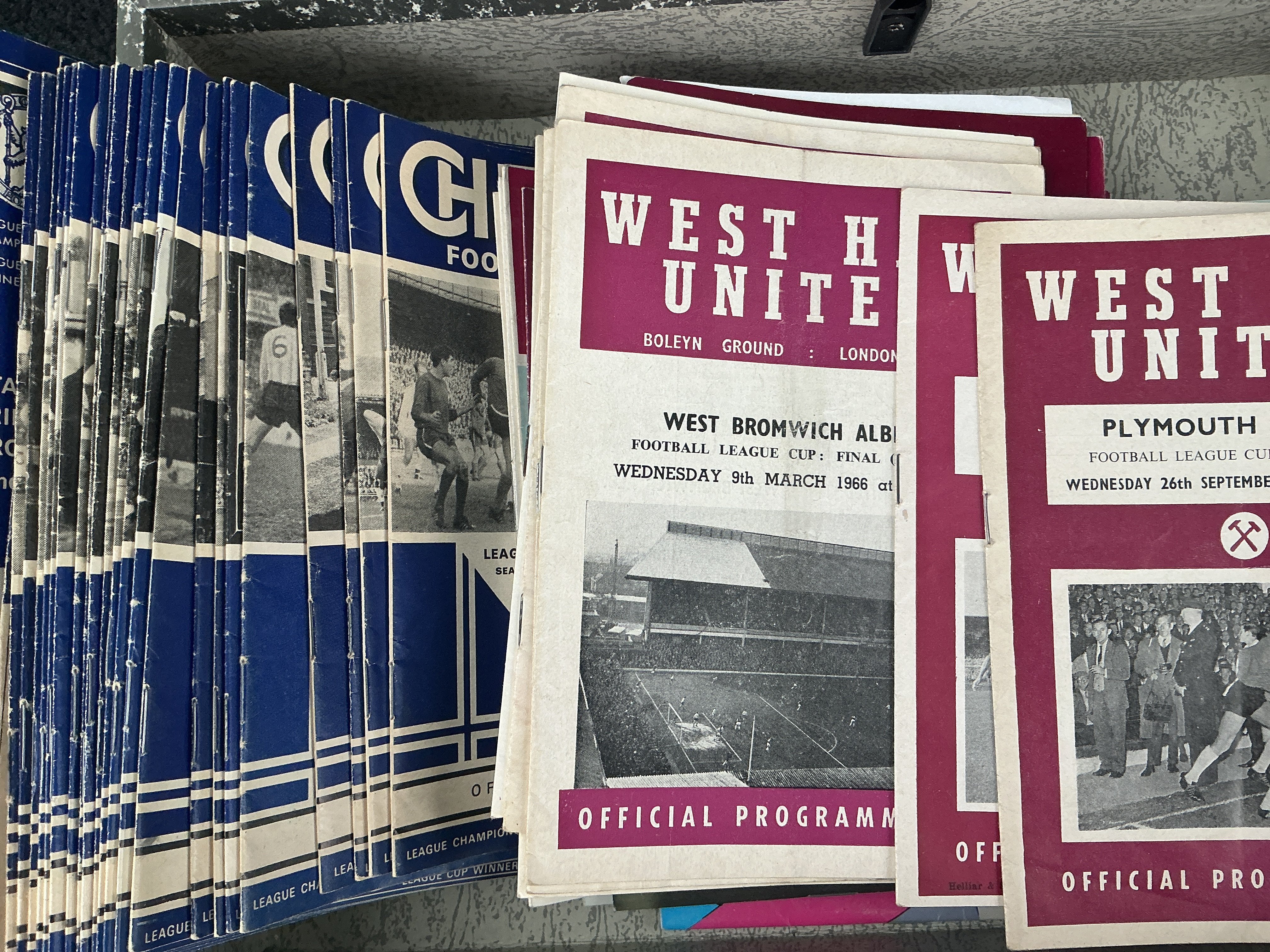 Football Programme Boxes: 31 Chelsea homes from the late 60s, over 40 West Ham homes from the 60s and 70s to include 1966 League Cup final and 62/63 Plymouth LC plus over 80 Tottenham from the same period. There are plenty more including big match from the 50s to the 90s. (2 boxes)