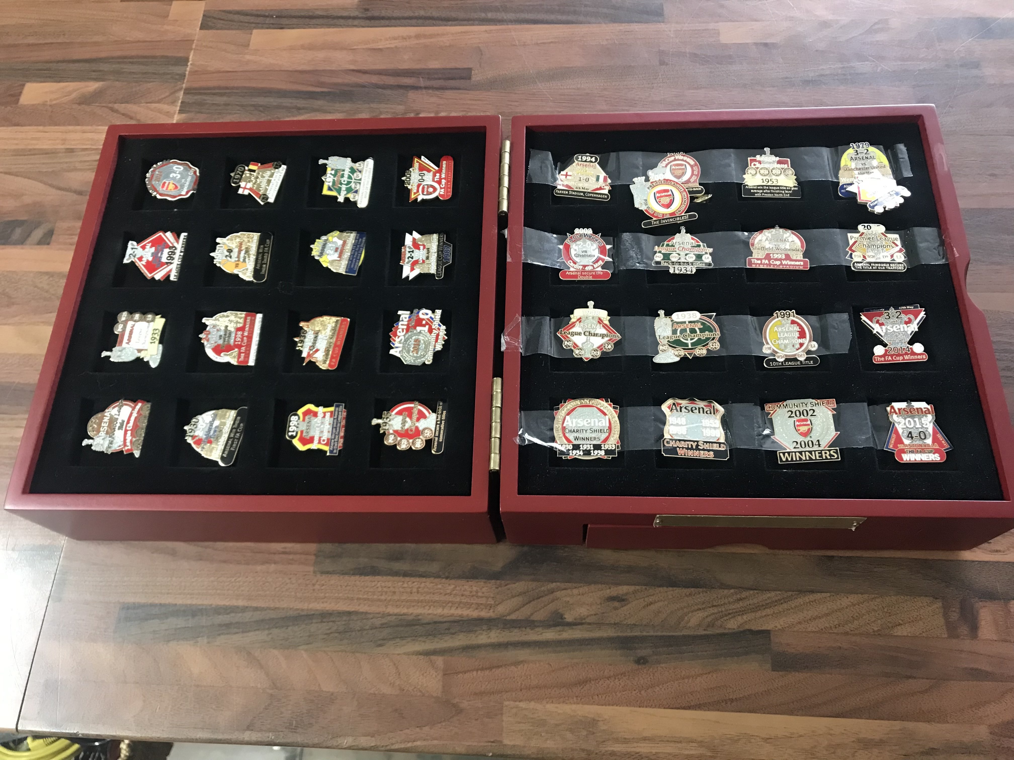 A collection of various Arsenal pin badges
