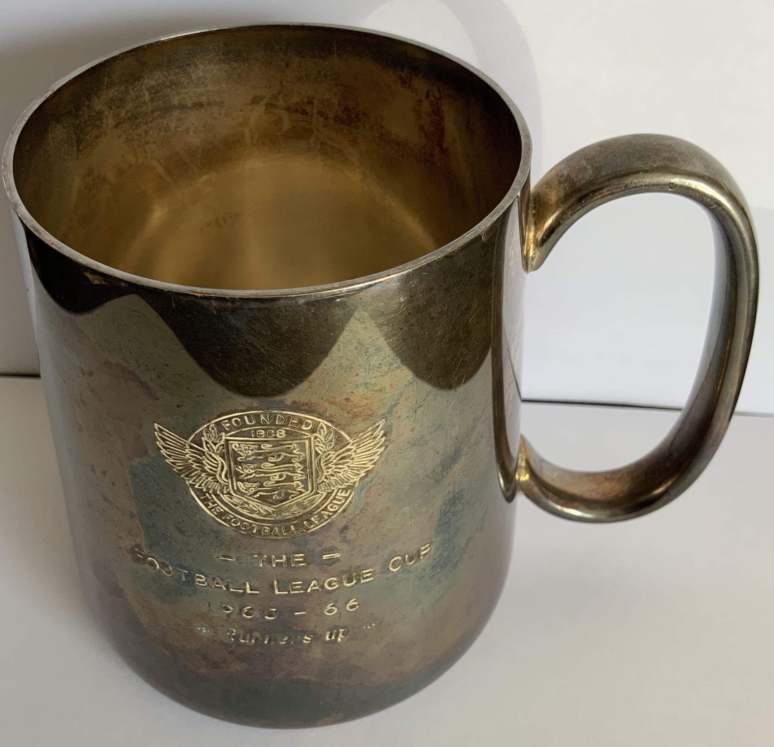 Ron Boyce West Ham 1966 League Cup Final Runners Up Tankard: Four inch tankard engraved with 1965 - 1966 Football League Cup runners up. Tankard is hallmarked to base. Metal is tarnished but otherwise in excellent condition.