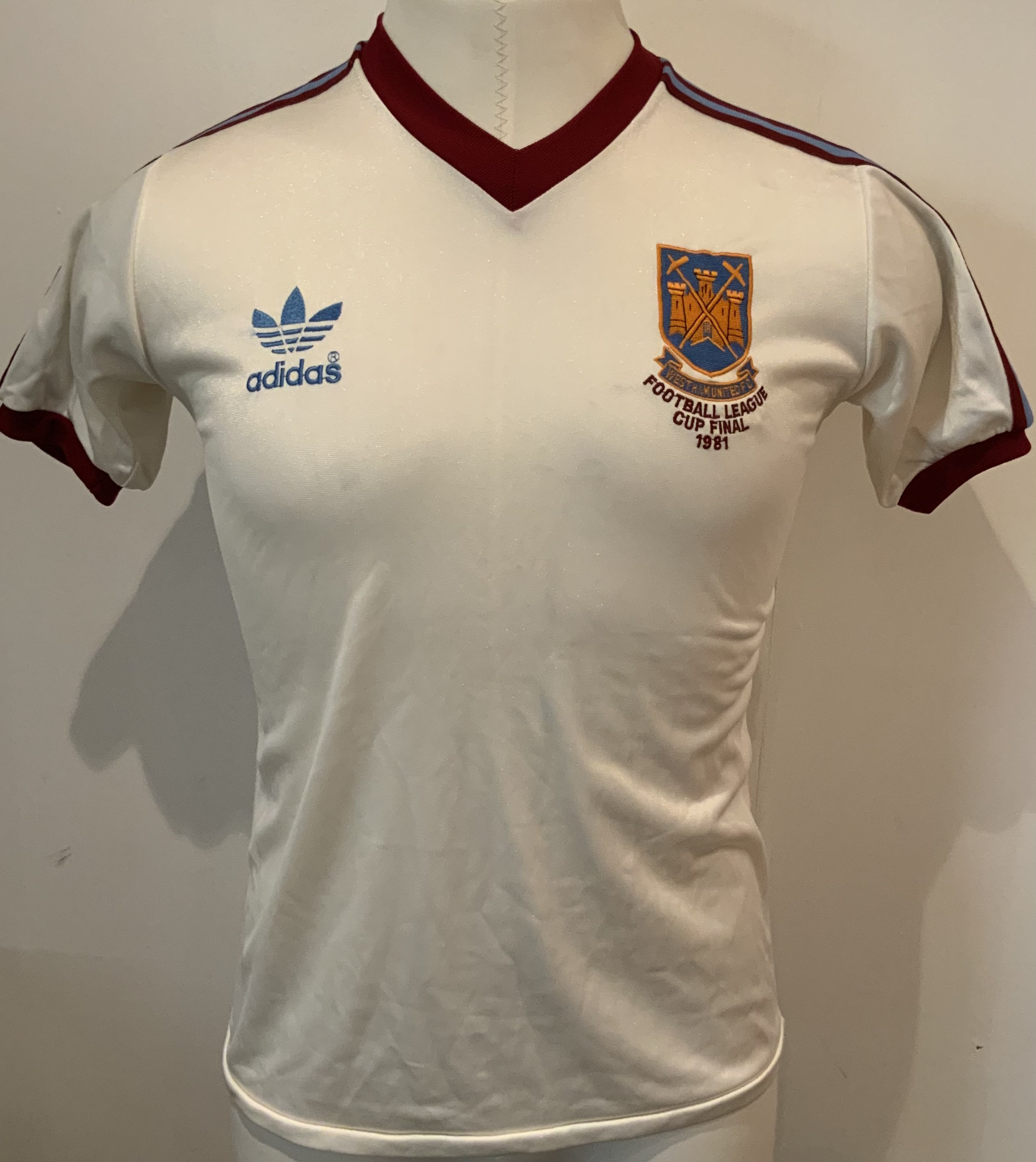 West Ham 1981 League Cup Final Football Shirt: Frank Lampards Adidas number 3 white shirt from the Final at Wembley which was given to Ron Boyce his friend and assistant manager. Ray Stewart scored a penalty to equalise with the last kick of the match after Clive Thomas had controversially allowed the Liverpool opener. In very good condition. No label to collar which we believe was standard for this competition.