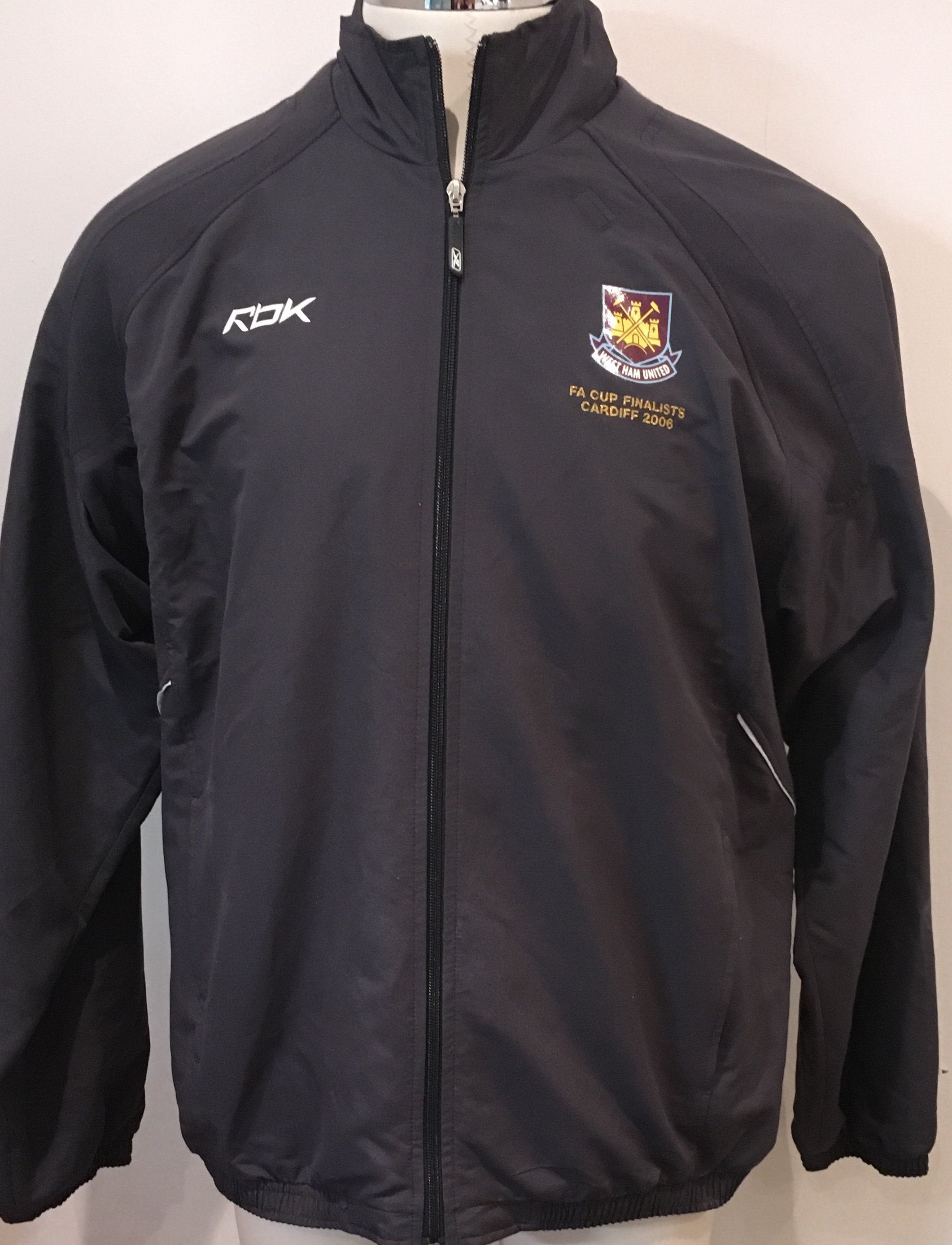 West Ham 2006 FA Cup Final Football Tracksuit: Grey Reebok Tracksuit in size XL worn by West Ham coach and former player Roger Cross. Top and bottoms featuring the old West Ham crest and has wording FA Cup Finalists Cardiff 2006. Excellent condition and never commercially available.