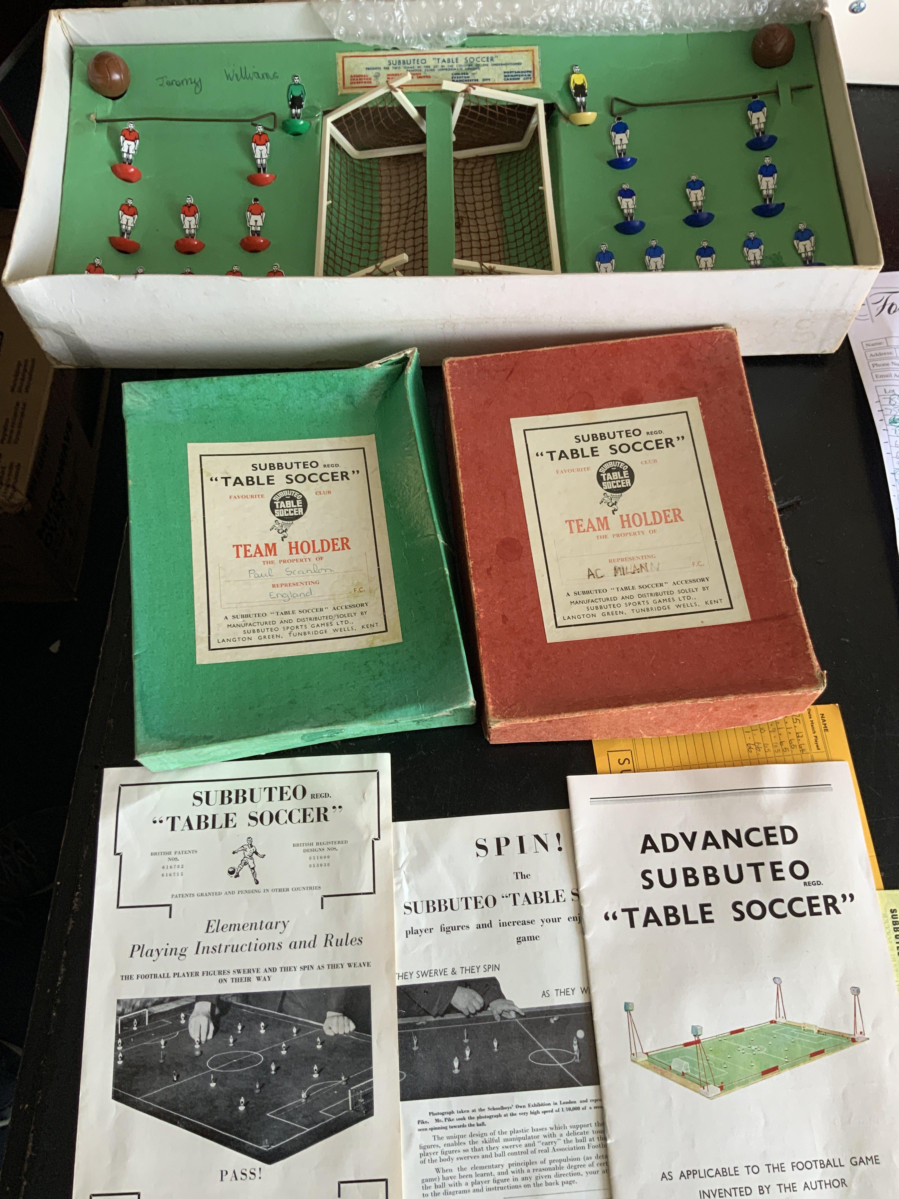 Subbuteto Football Games: 1964 Super Set which is believed to be complete of everything with rules etc. C/W two empty team holders in below average condition in green and red. C/W Emlyn Hughes Soccer Management Game and mug and keyring set.