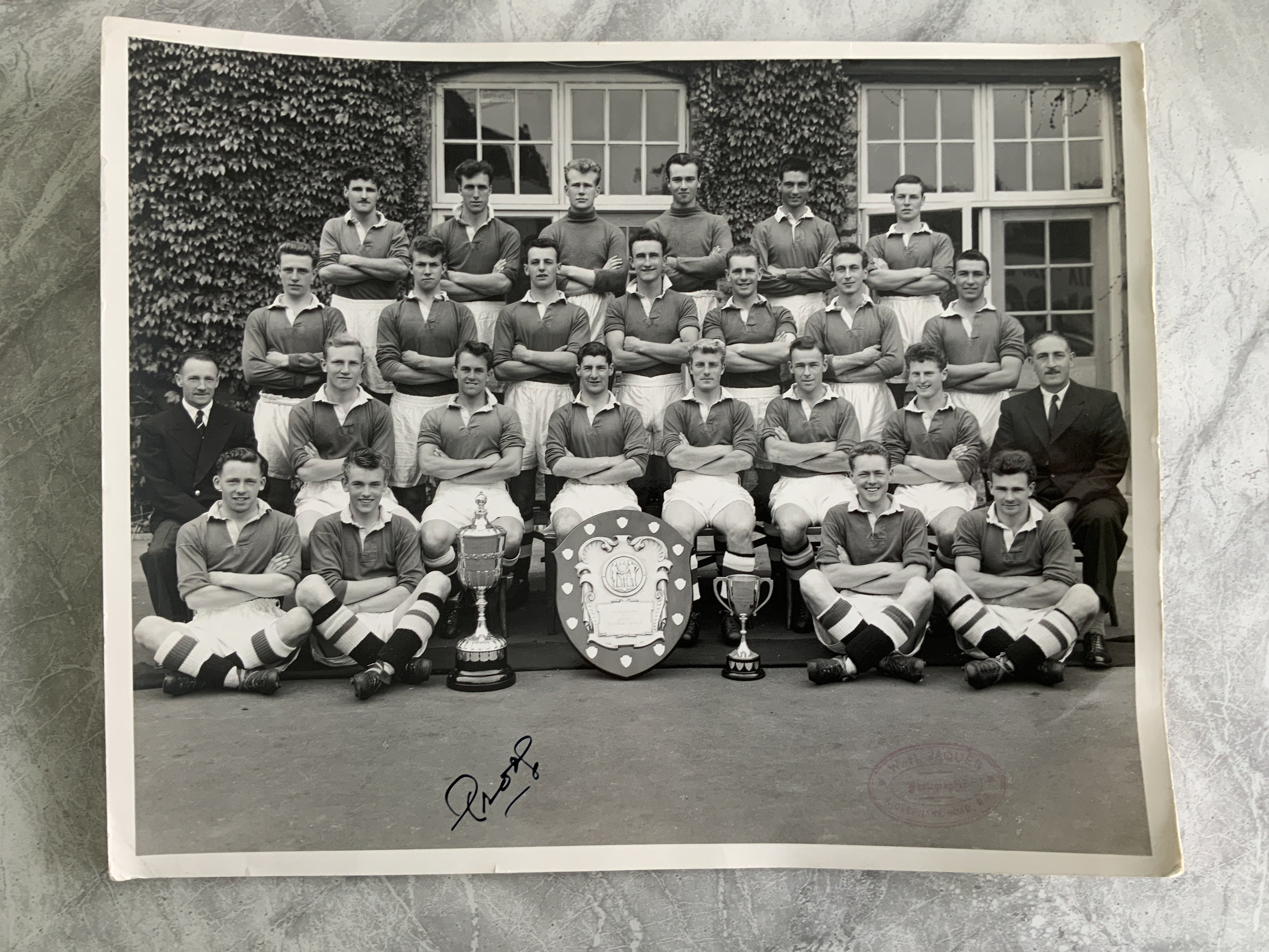 Chelsea 1955 Champions Team Group Press Photo: Almost 12 x 10 inches taken at the beginning of the 55/56 season with 3 cups present in front of 23 players plus management. The front has press stamp and word prog which meant this was the photograph used for the programme.