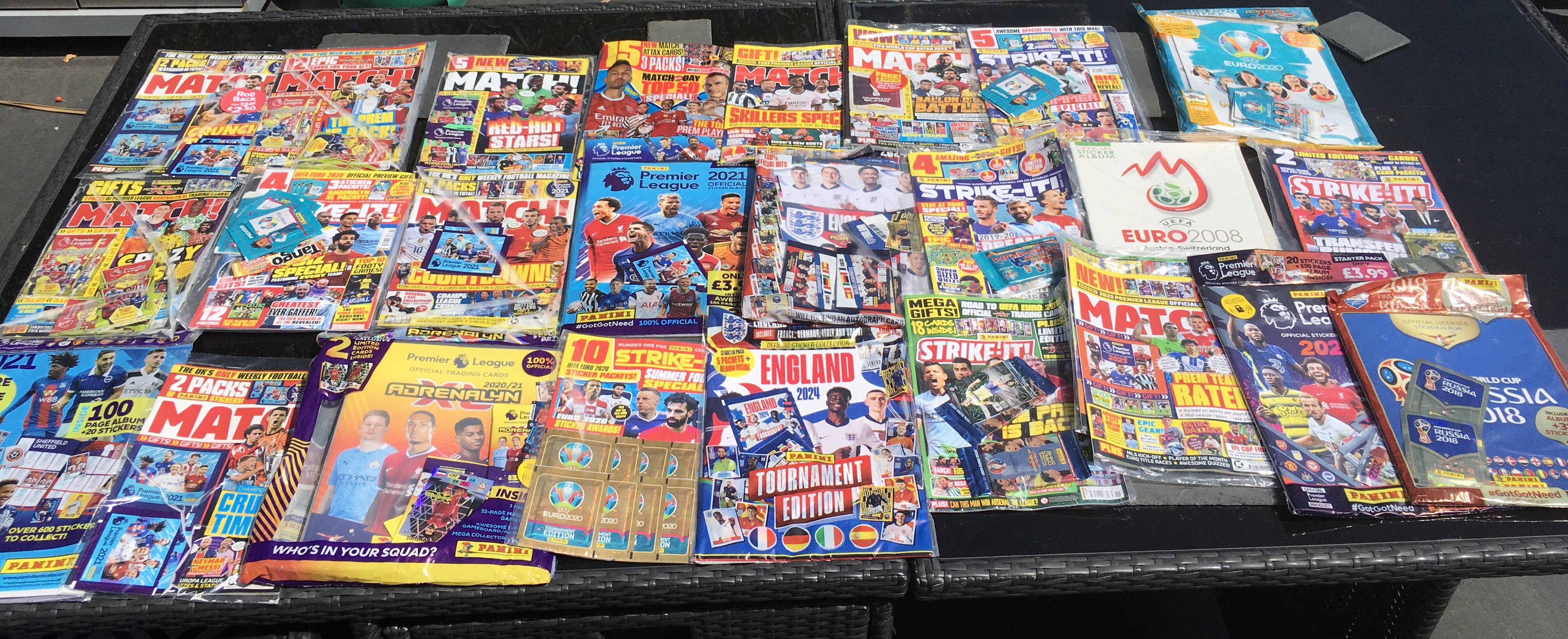 Panini Sealed Football Card Collection: Around 30 sealed metal tins or sealed packs housed in cardboard from a modern era with a minimum of 8 pounds paid each per pack. Numerous magazines with free packs to encourage collecting plus some sealed empty albums and packs. Very large quantity which must have cost around 400 pounds when new.